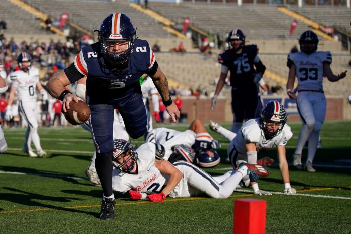 Jared Curtis (2) runs in a touchdown against Columbia Academy during the first quarter of the Division II-A championship game