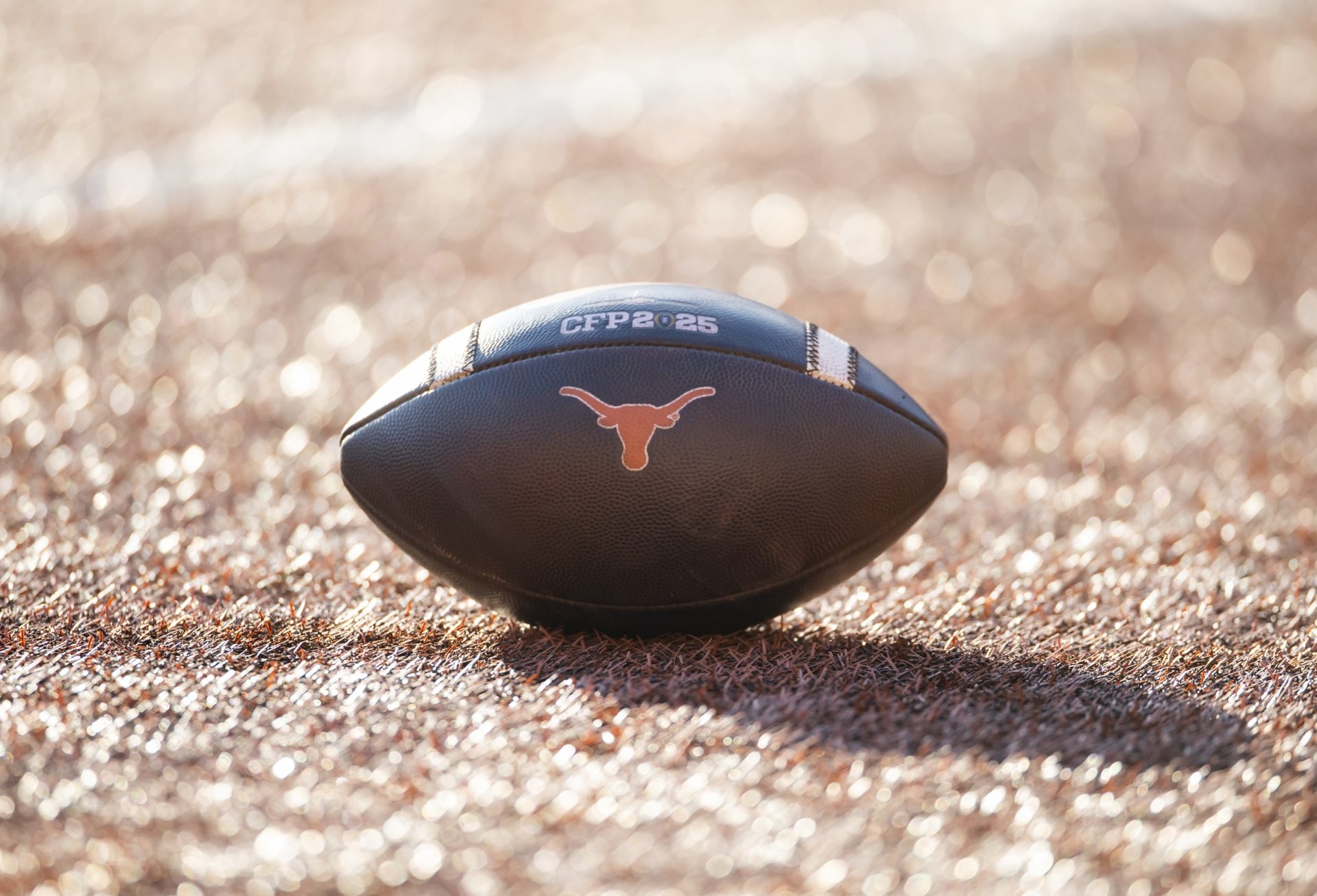 Detailed view of a Texas Longhorns logo on an official NCAA football on the field during the CFP National playoff first round