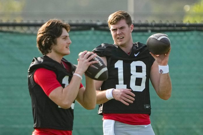 Ohio State Buckeyes quarterback Will Howard (18) talks to quarterback Julian Sayin (10) during practice for the Rose Bowl