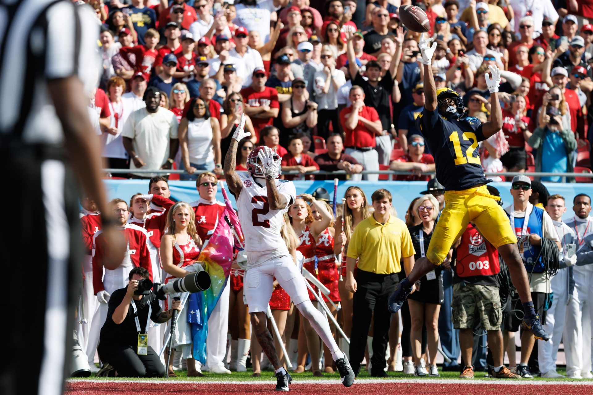 Michigan Wolverines defensive back Aamir Hall (12) attempts to break up a pass to Alabama Crimson Tide wide receiver Ryan Williams (2) during the first half at Raymond James Stadium.