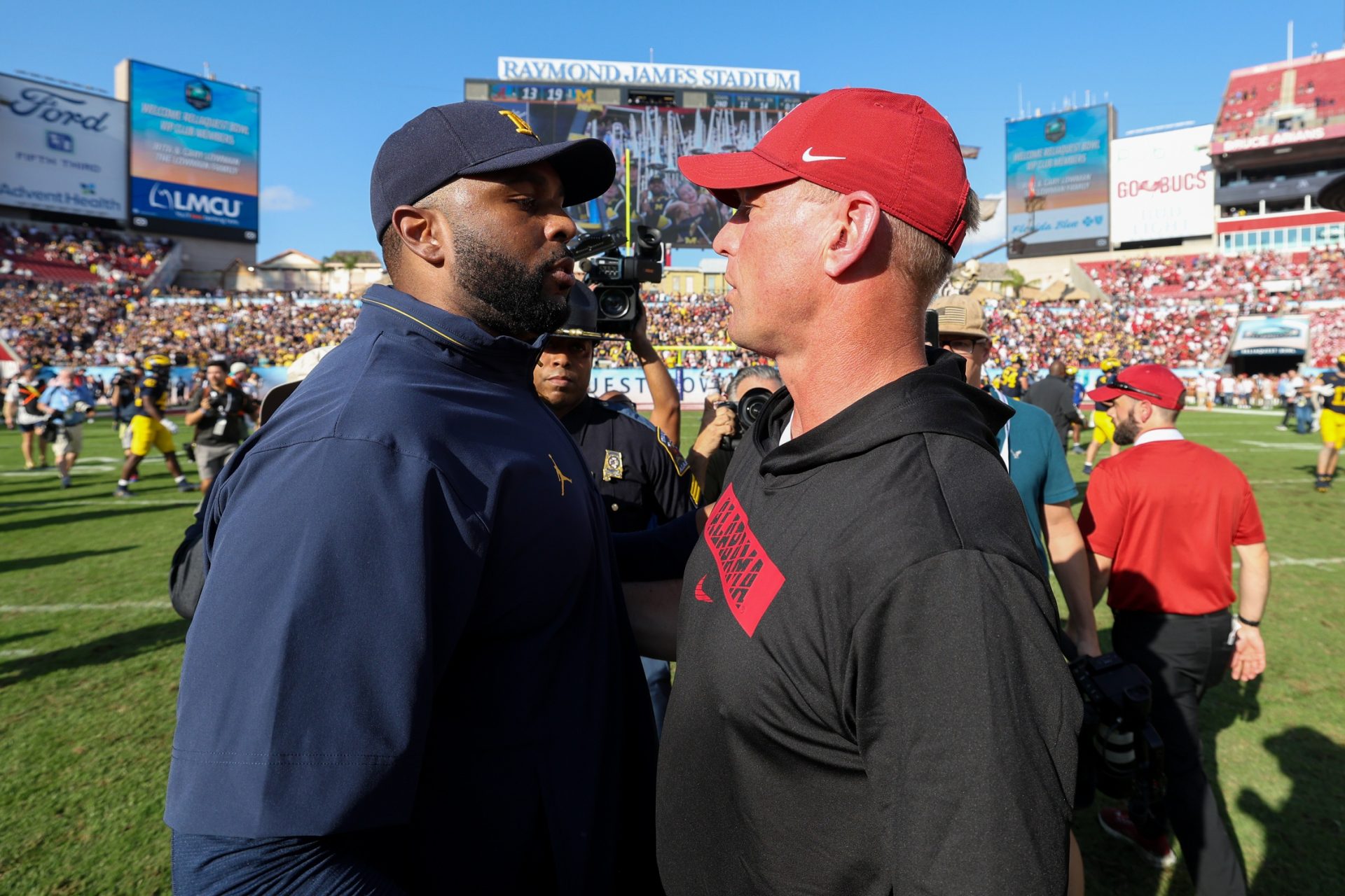 Michigan Wolverines head coach Sherrone Moore greets Alabama Crimson Tide head coach Kalen Deboer after the ReliaQuest Bowl at Raymond James Stadium.