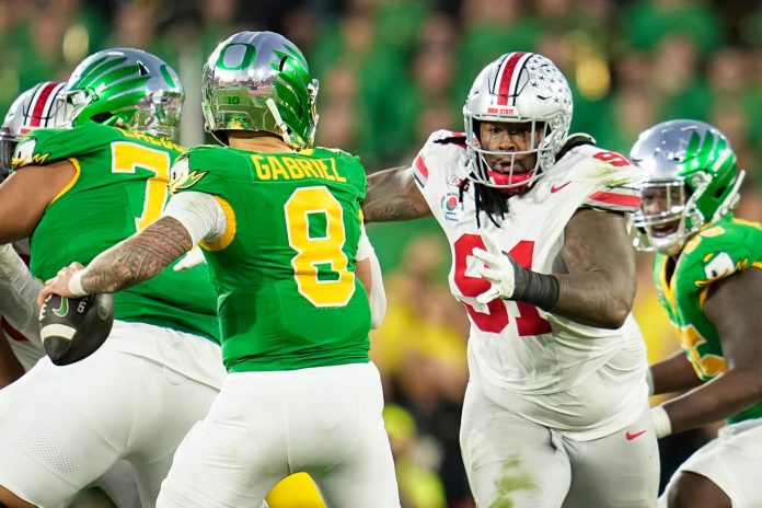 Ohio State Buckeyes defensive tackle Tyleik Williams (91) rushes at Oregon Ducks quarterback Dillon Gabriel (8) during the second half of the College Football Playoff quarterfinal at the Rose Bowl in Pasadena, Calif. on Jan. 1, 2025. Ohio State won 41-21.