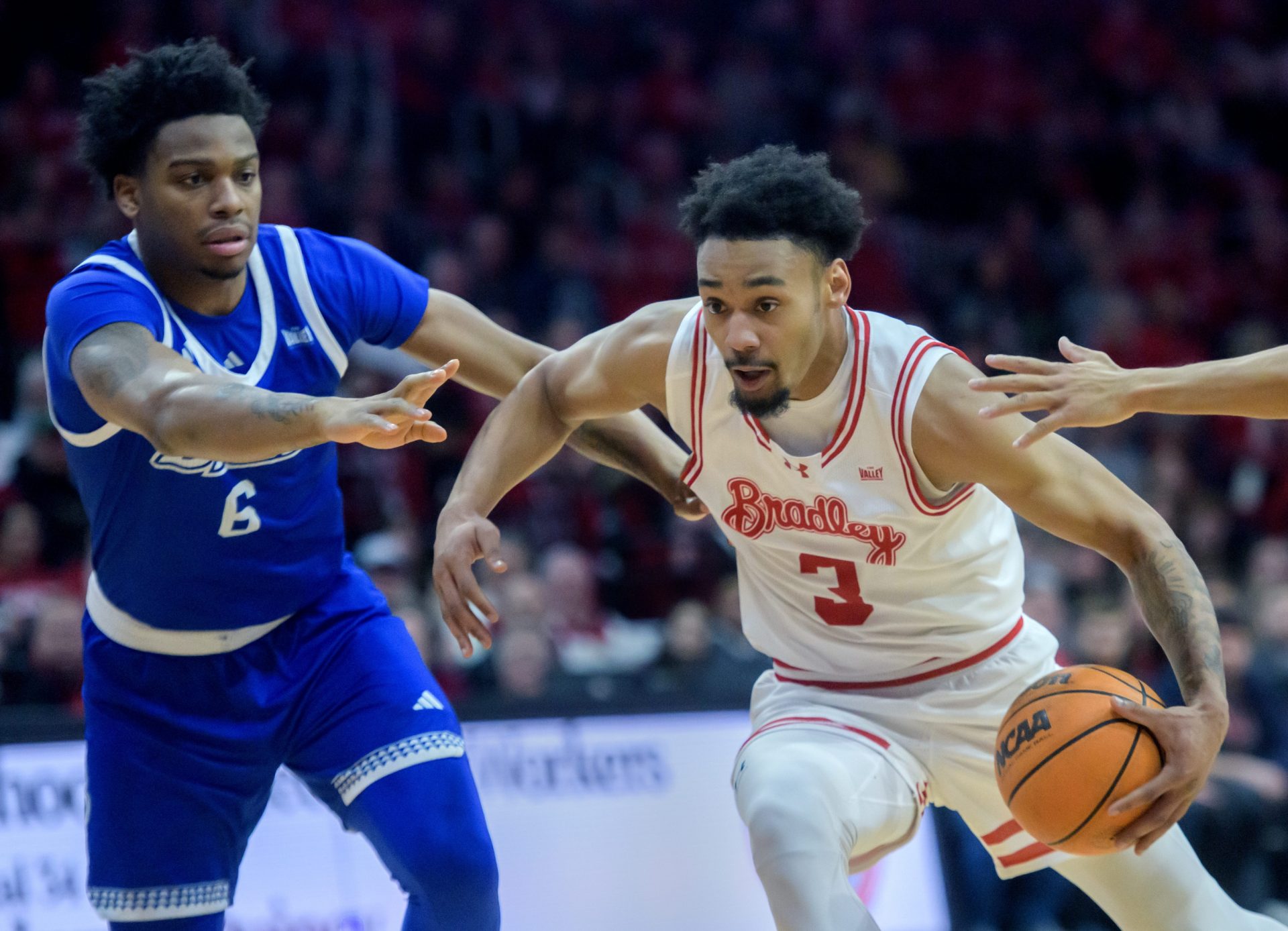 Bradley’s Zek Montgomery, right, moves the ball against Drake’s Tavion Banks in the first half of their Missouri Valley Conference basketball game Wednesday, Jan. 8, 2025 at Carver Arena.