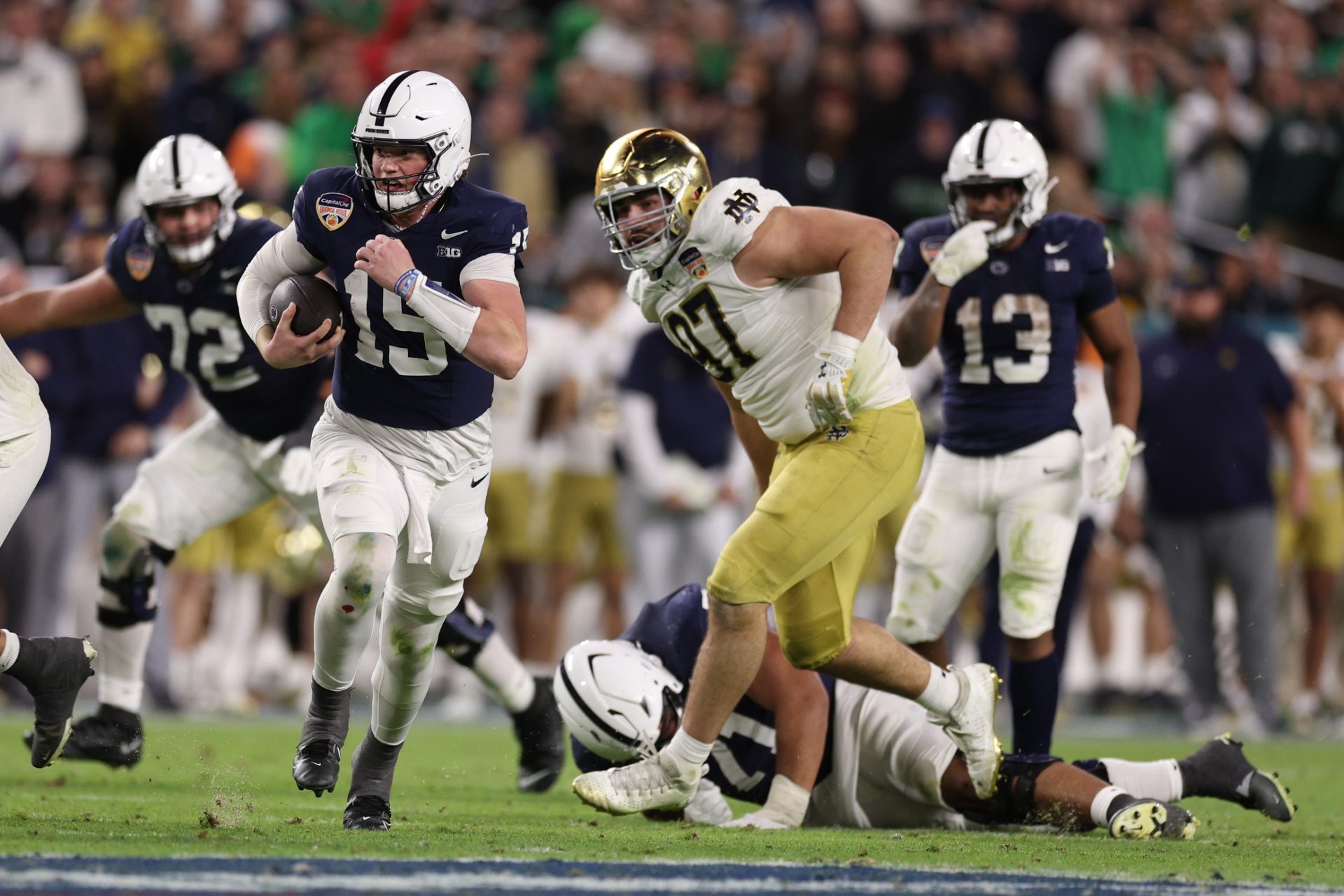 Penn State Nittany Lions quarterback Drew Allar (15) runs the ball in the second half against the Notre Dame Fighting Irish in the Orange Bowl at Hard Rock Stadium.