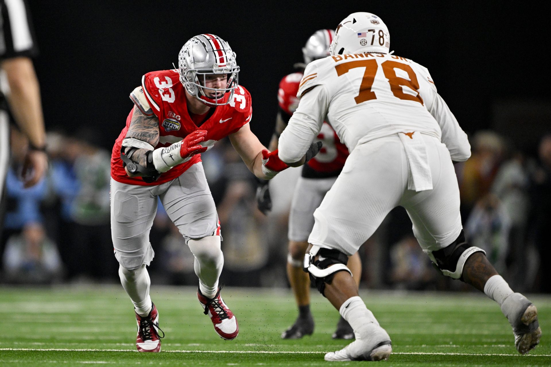 Ohio State Buckeyes defensive end Jack Sawyer (33) rushes against Texas Longhorns offensive lineman Kelvin Banks Jr. (78) during the game at AT&T Stadium.