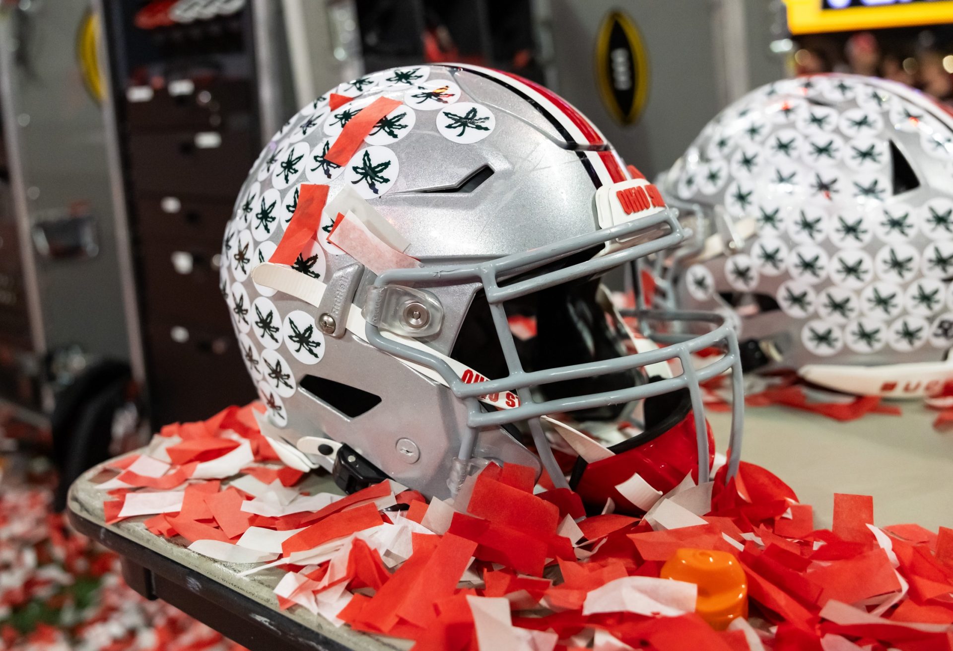 Detailed view of confetti with an Ohio State Buckeyes helmet after winning the CFP National Championship college football game at Mercedes-Benz Stadium.