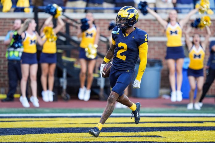 Michigan defensive back Will Johnson celebrates a touchdown after intercepting USC quarterback Miller Moss during the second half at Michigan Stadium in Ann Arbor on Saturday, Sept. 21, 2024.