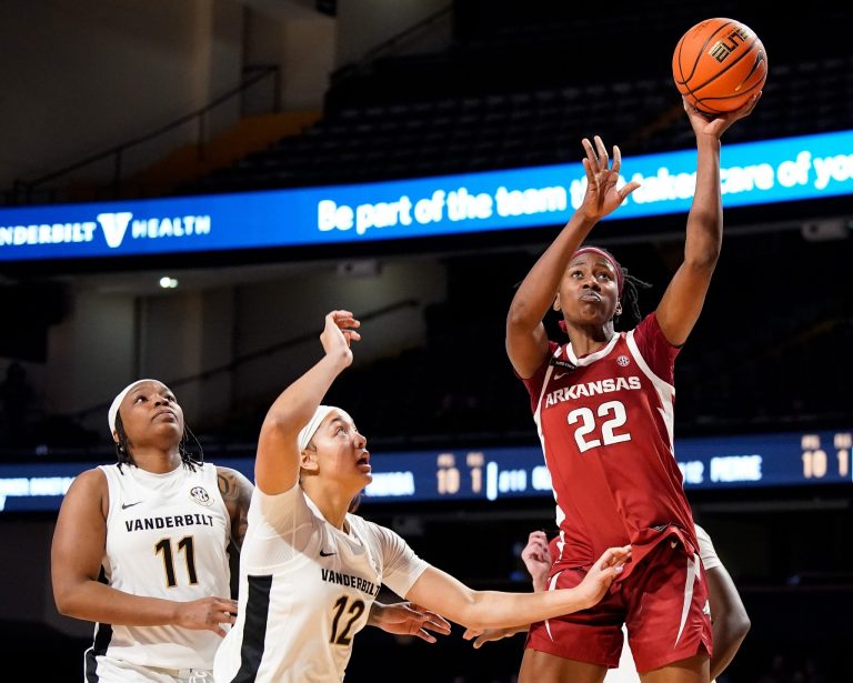 Arkansas forward Vera Ojenuwa (22) shoots past Vanderbilt guard Jordyn Oliver (11) and forward Khamil Pierre (12)