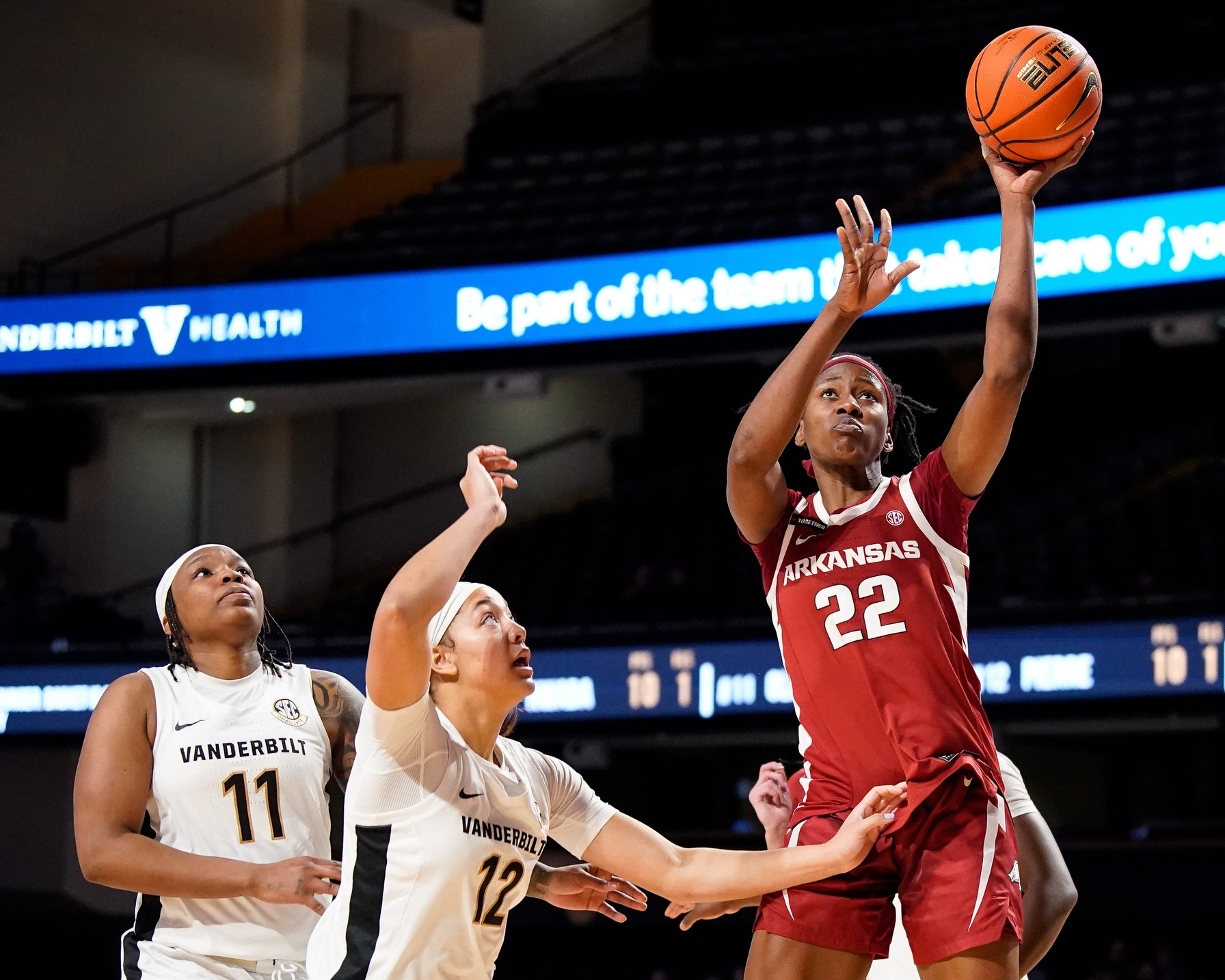 Arkansas forward Vera Ojenuwa (22) shoots past Vanderbilt guard Jordyn Oliver (11) and forward Khamil Pierre (12)