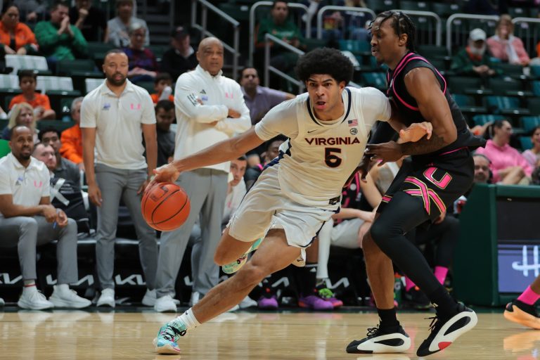 Virginia Cavaliers forward Jacob Cofie (5) drives o the basket past Miami Hurricanes guard Paul Djobet (10) during the first half at Watsco Center.