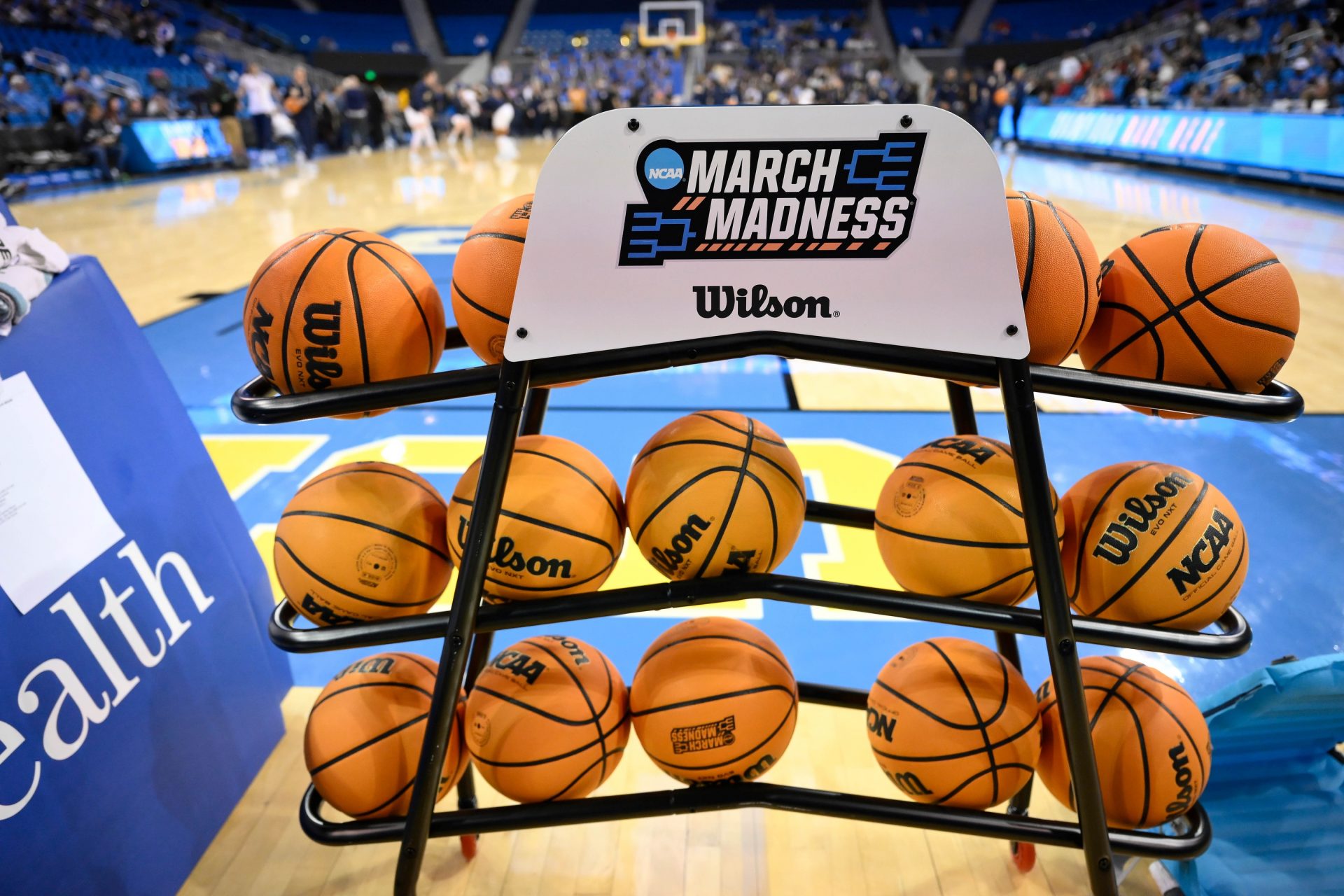 A rack of basketballs with the March Madness logo before that start of the UCLA Bruins - Ohio State