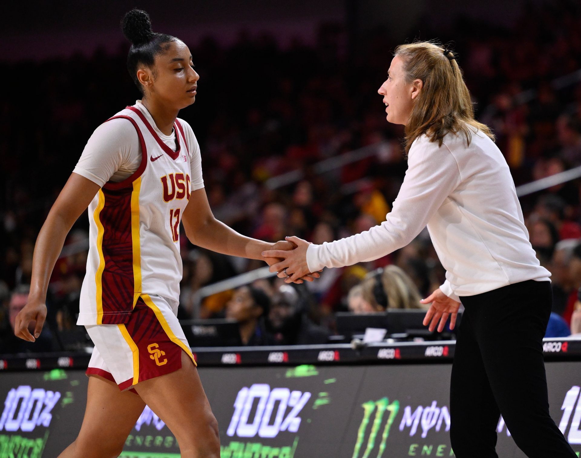 USC Trojans guard JuJu Watkins (12) slaps hands with USC Trojans head coach Lindsay Gottlieb was she comes out of the game in the fourth quarter against the Ohio State Buckeyes at Galen Center.