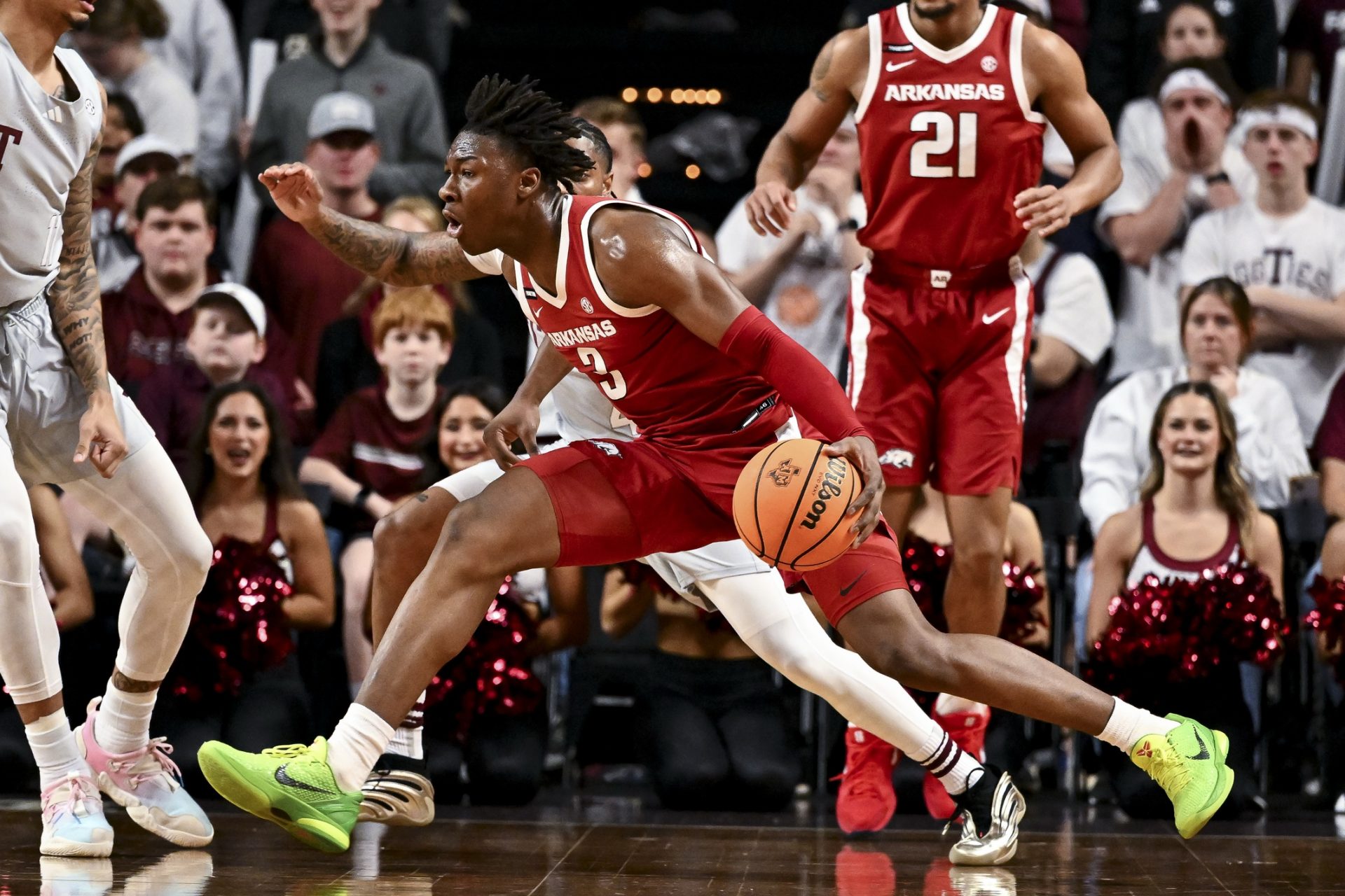 Arkansas Razorbacks forward Adou Thiero (3) drives against Texas A&M Aggies guard Wade Taylor IV (4) during the first half at Reed Arena.