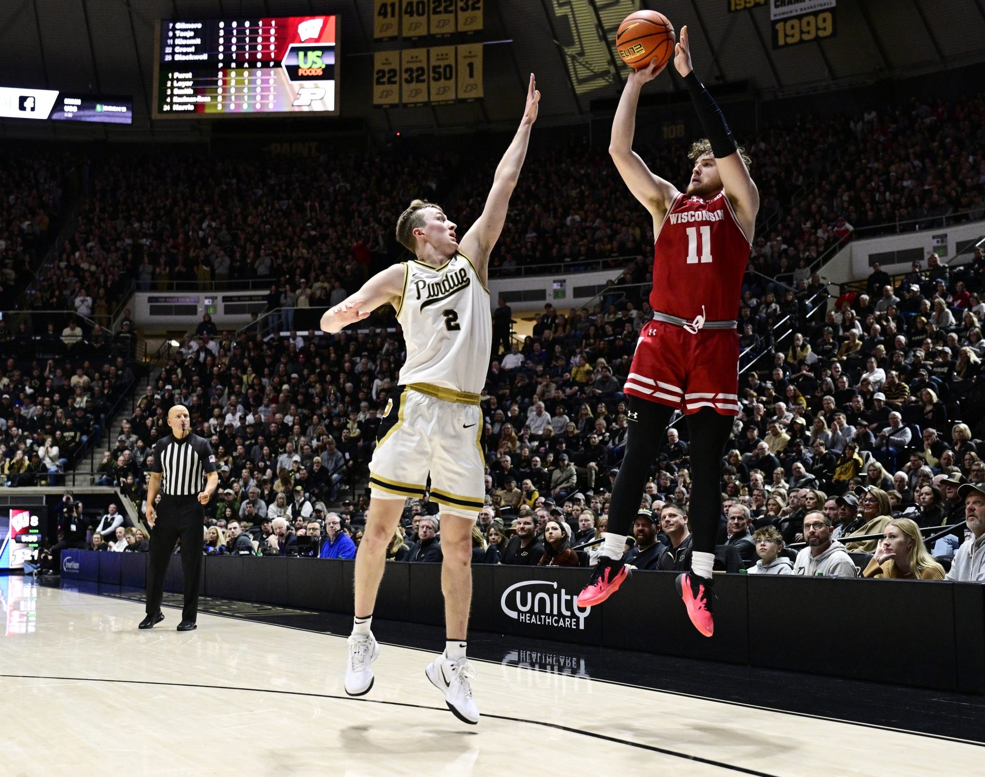 Wisconsin Badgers guard Max Klesmit (11) shoots the ball over Purdue Boilermakers guard Fletcher Loyer (2) during the first half at Mackey Arena.