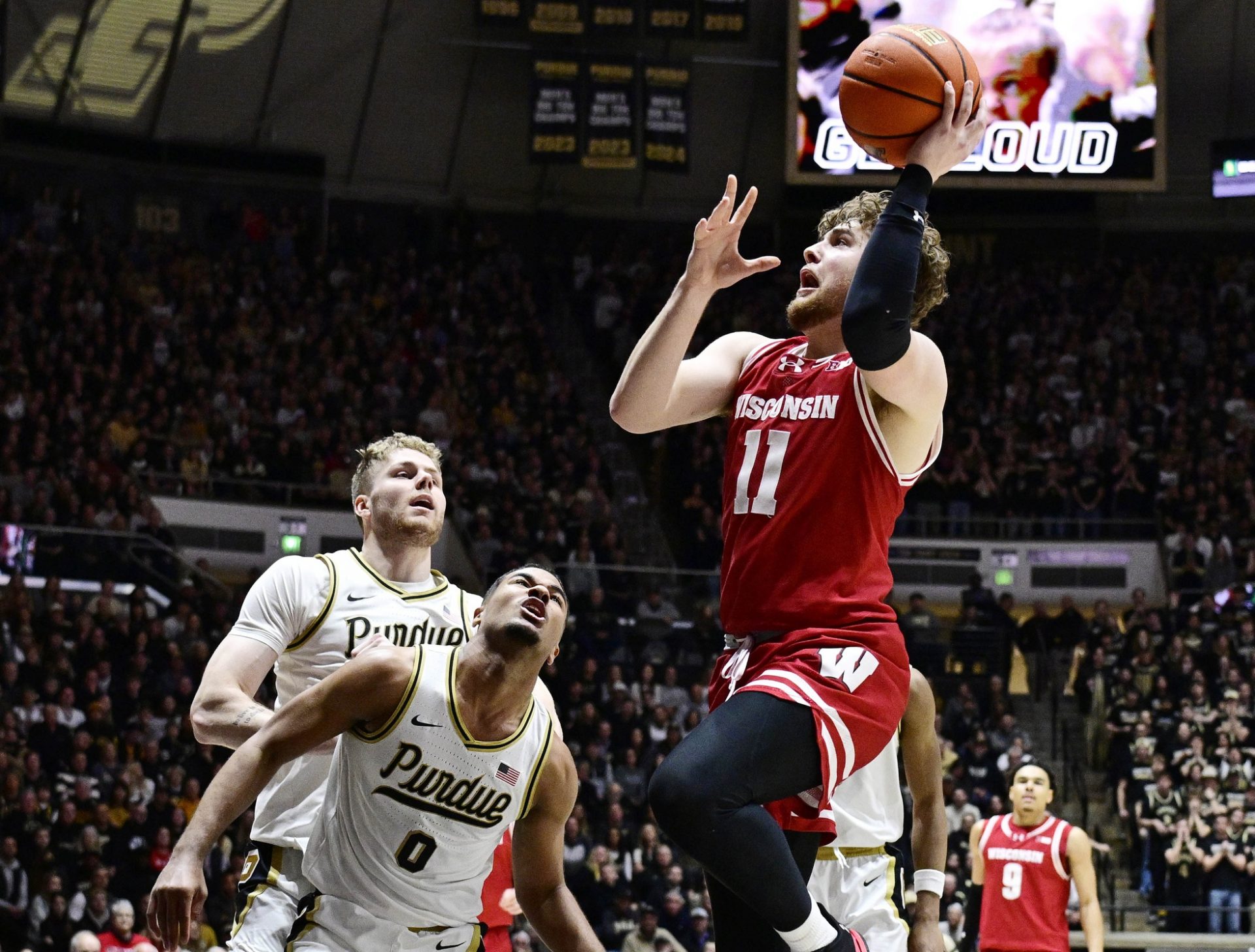 isconsin Badgers guard Max Klesmit (11) shoots the ball in front of Purdue Boilermakers