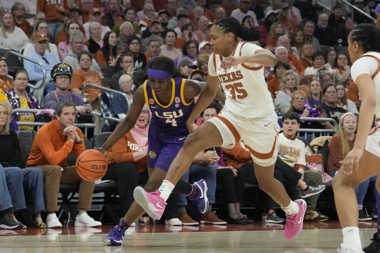 Louisiana State Lady Tigers guard Flau'jae Johnson (4) dribbles around Texas Longhorns forward Madison Booker (35) during the second half at Moody Center.