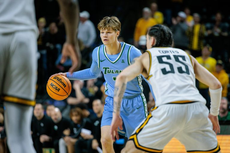 Tulane Green Wave guard Kam Williams (3) brings the ball up court around Wichita State Shockers guard Bijan Cortes (55) during the first half at Charles Koch Arena.