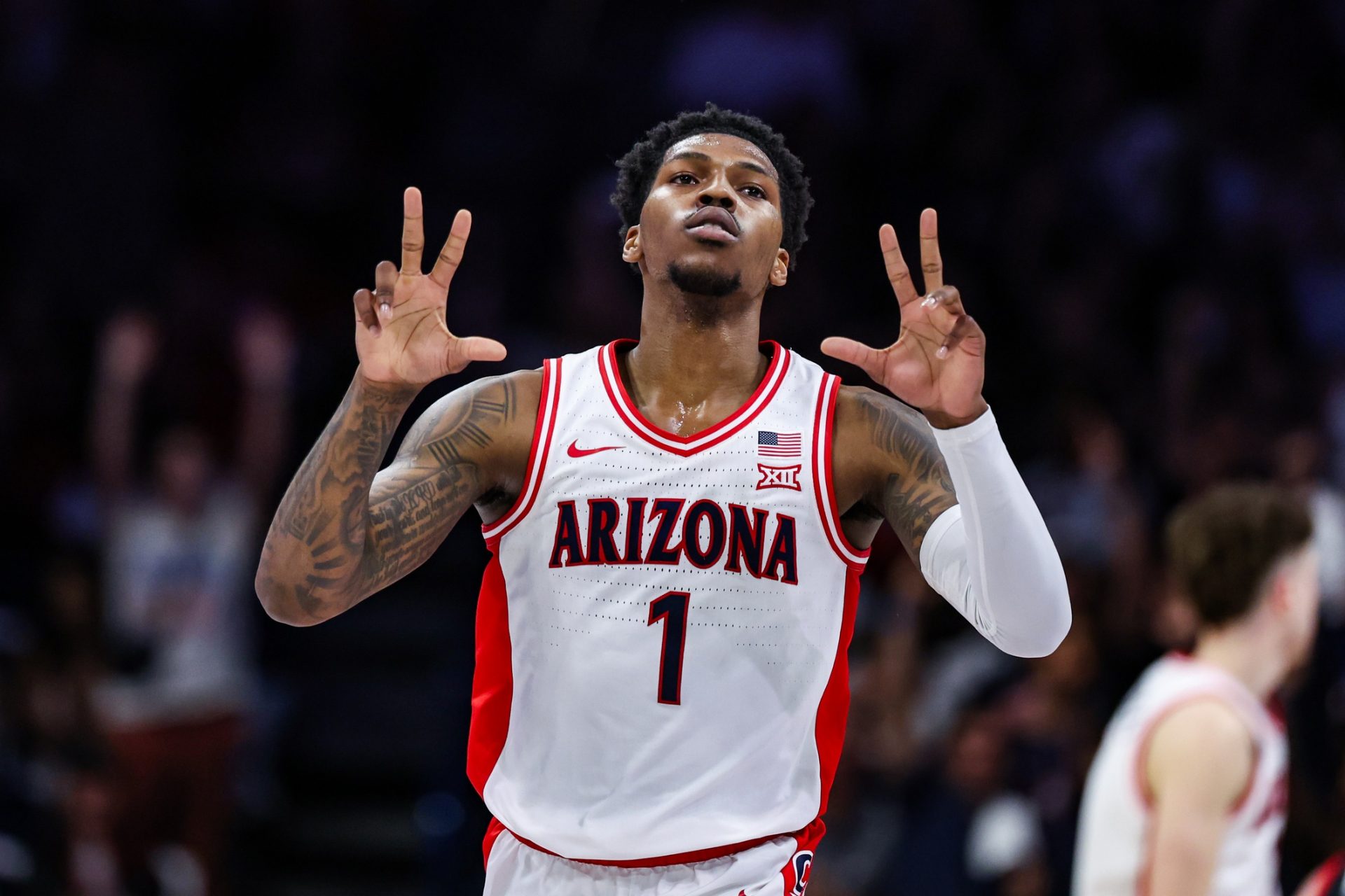 Arizona Wildcats guard Caleb Love (1) holds up threes after he shot a three point basket during the first half against the Utah Utes at McKale Center.