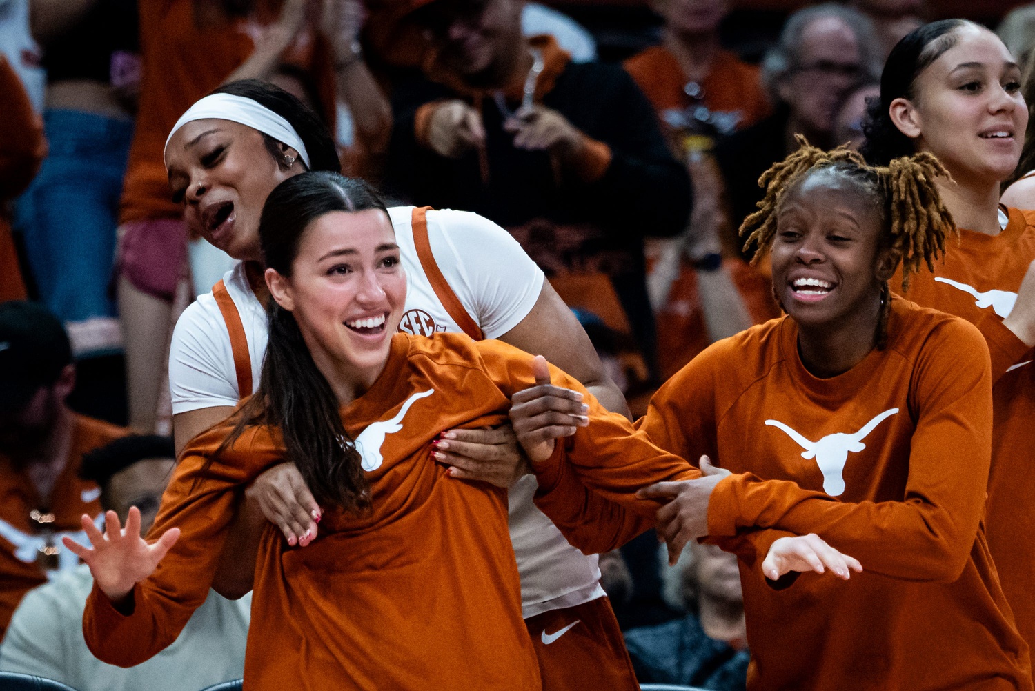 Texas Longhorns forward Aaliyah Moore (23) celebrates from the bench with guards Sarah Graves (25) and Bryanna Preston (1) in the second half of the Texas Longhorns' game against the Florida Gators, March 2, 2025.