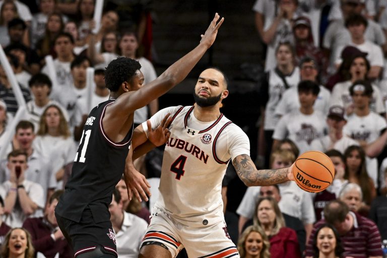 Auburn Tigers forward Johni Broome (4) passes the ball as Texas A&M Aggies forward Pharrel Payne (21) defends during the first half at Reed Arena.