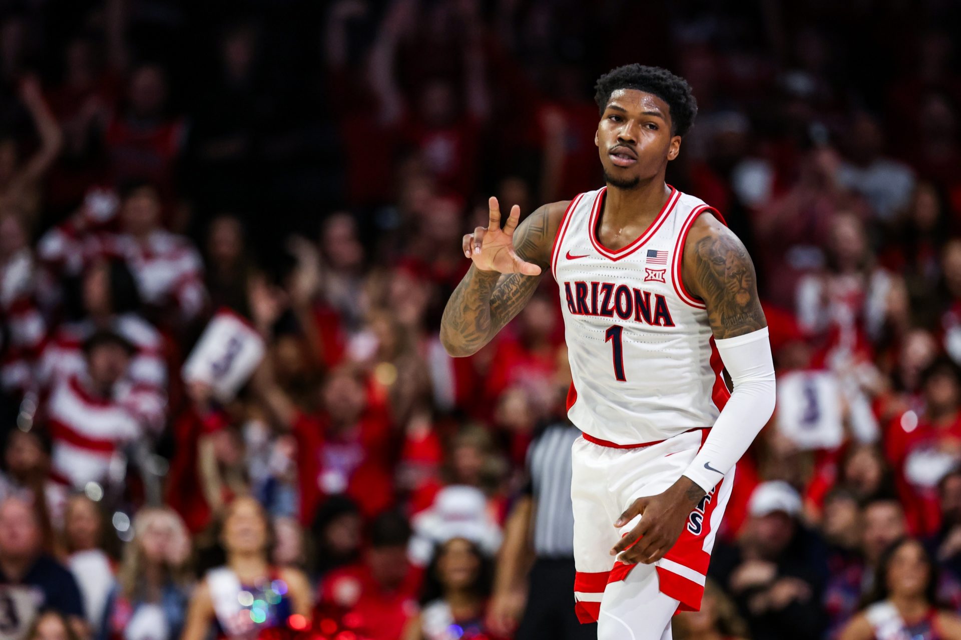 Arizona Wildcats guard Caleb Love (1) holds up a three after he makes a three-point basket during the first half against the Arizona State Sun Devils at McKale Center.