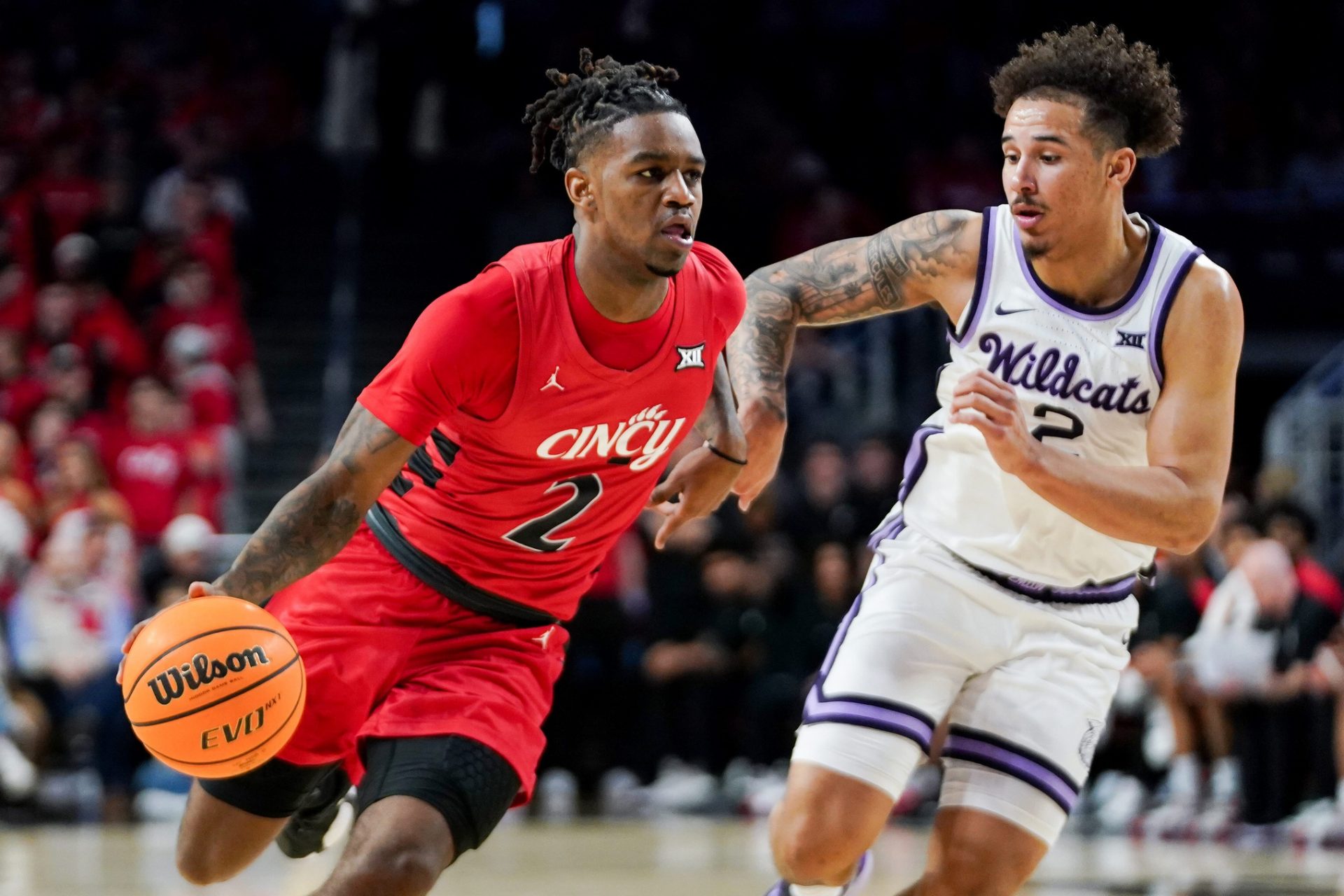 Cincinnati Bearcats guard Jizzle James (2) attempts to drive past Kansas State Wildcats guard Max Jones (2) in the first half of a NCAA men’s basketball game between the Cincinnati Bearcats and Kansas State Wildcats, Wednesday, March 5, 2025, at Fifth Third Arena in Cincinnati.