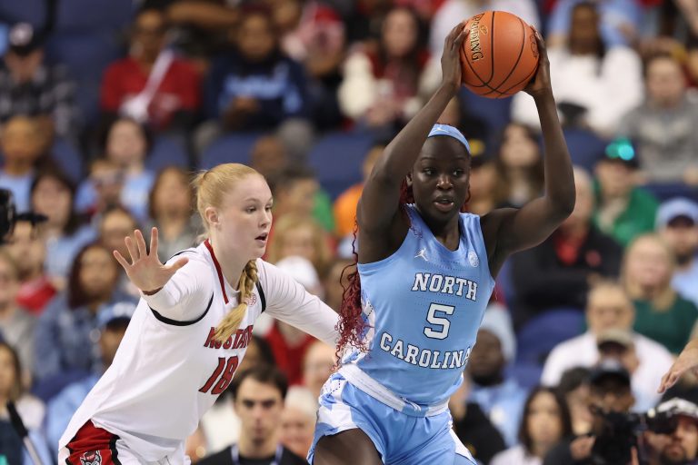 North Carolina Tar Heels forward Maria Gakdeng (5) sets the play against NC State Wolfpack forward Tilda Trygger (18) during the third quarter at First Horizon Coliseum.