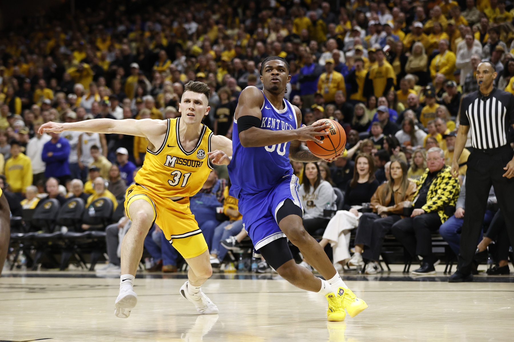 Kentucky Wildcats guard Otega Oweh (00) drives past Missouri Tigers guard Caleb Grill (31) in the second half at Mizzou Arena.