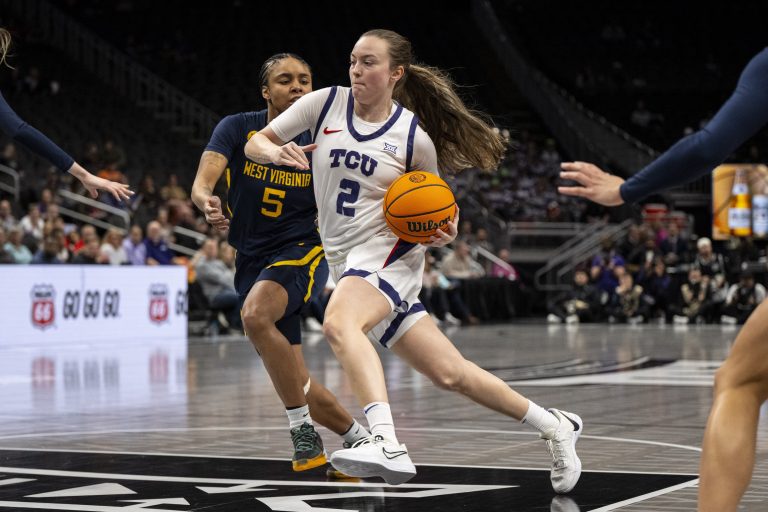 TCU Horned Frogs guard Madison Conner (2) handles the ball while defended by West Virginia Mountaineers guard Sydney Shaw (5) during the first half at T-Mobile Center.