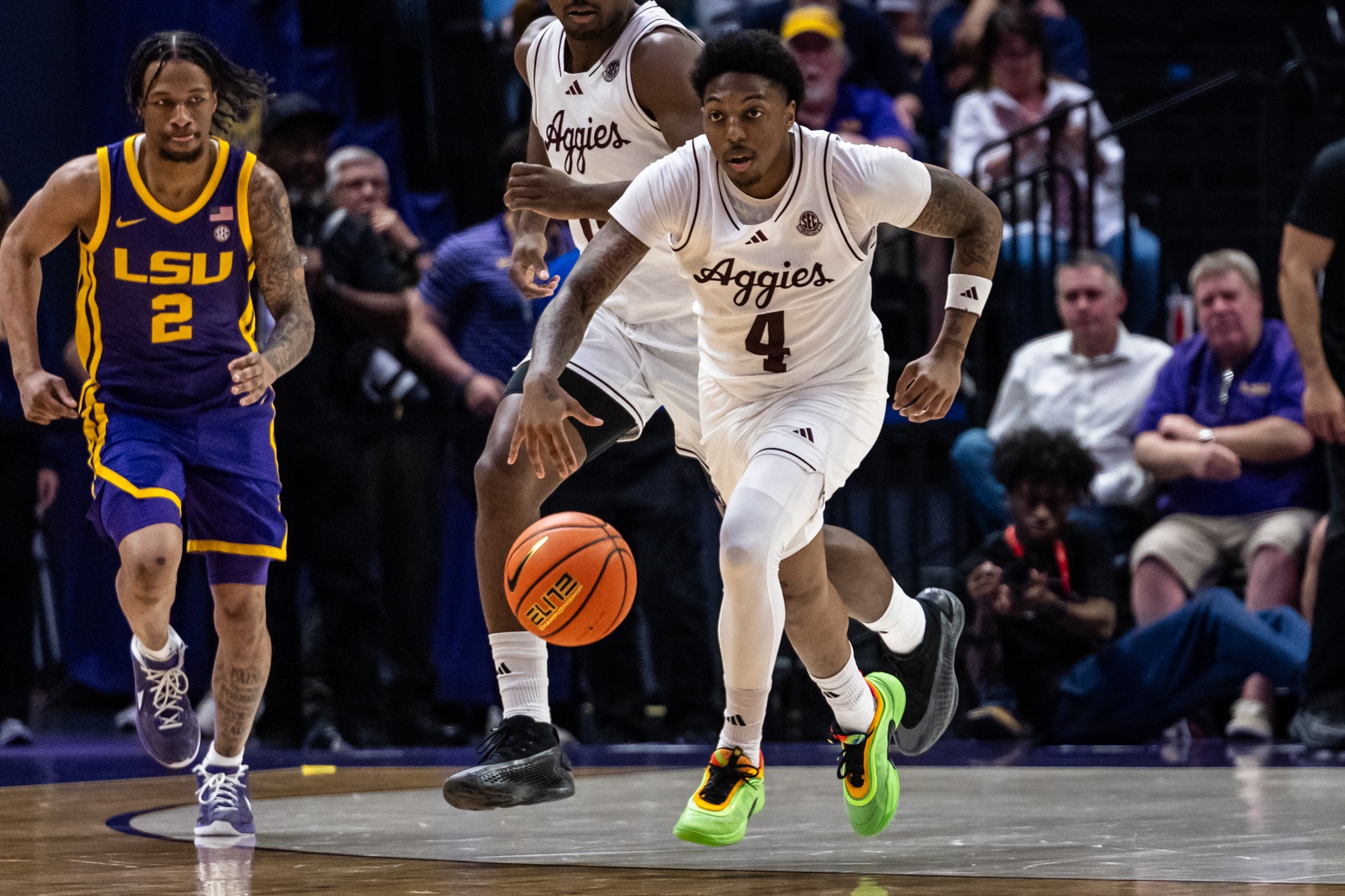 Aggies guard Wade Taylor IV (4) brings the ball up court against LSU Tigers guard Mike Williams III (2) during the second half