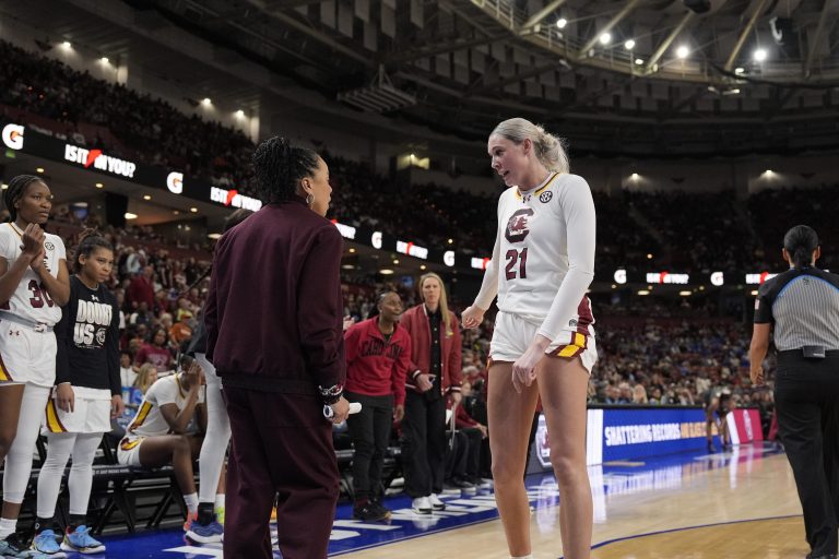 South Carolina Gamecocks head coach Dawn Staley talks with forward Chloe Kitts (21) during a free throw during the second half against the Oklahoma Sooners at Bon Secours Wellness Arena.