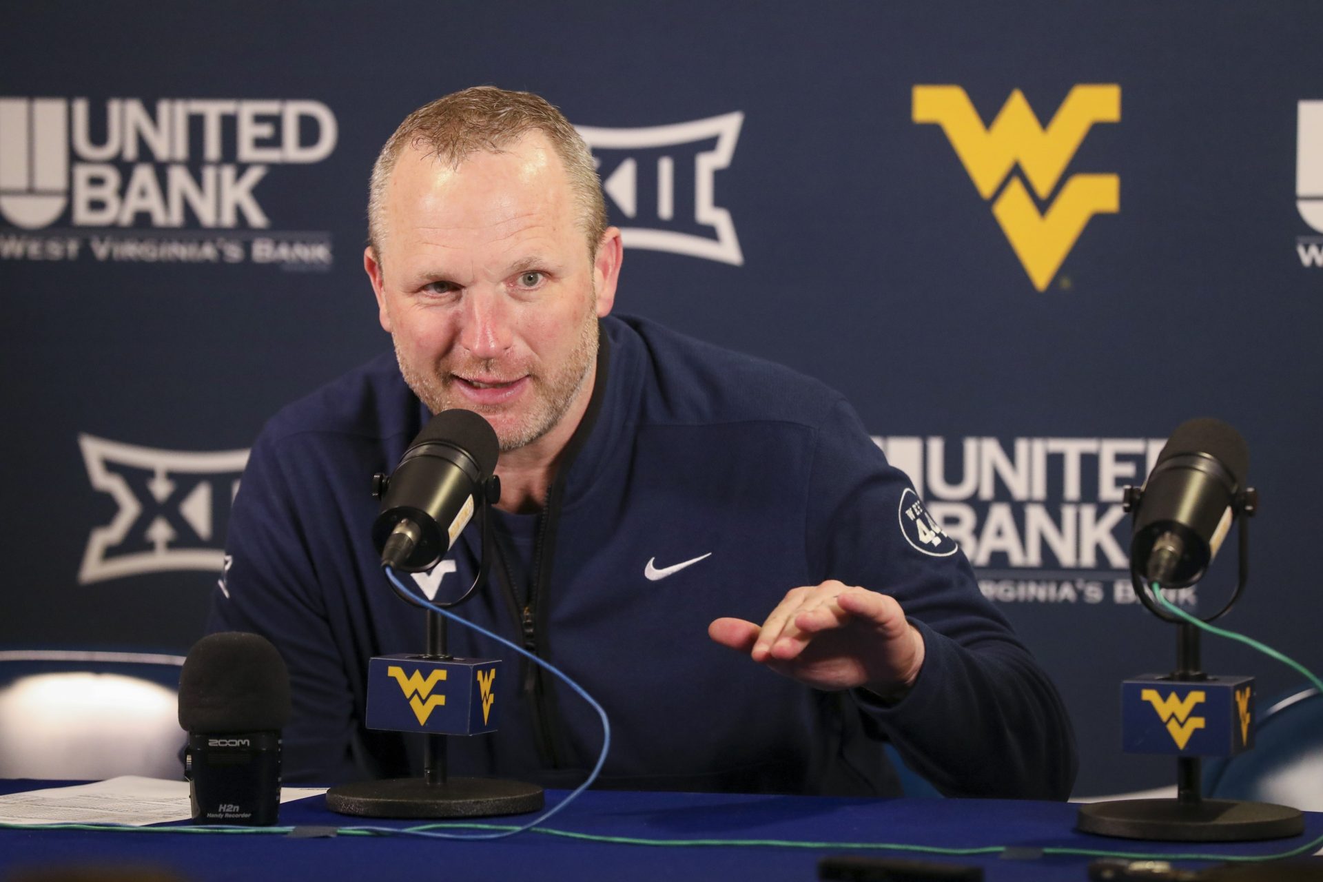 West Virginia, USA; West Virginia Mountaineers head coach Darian DeVries answers questions from the media after defeating the UCF Knights at WVU Coliseum.