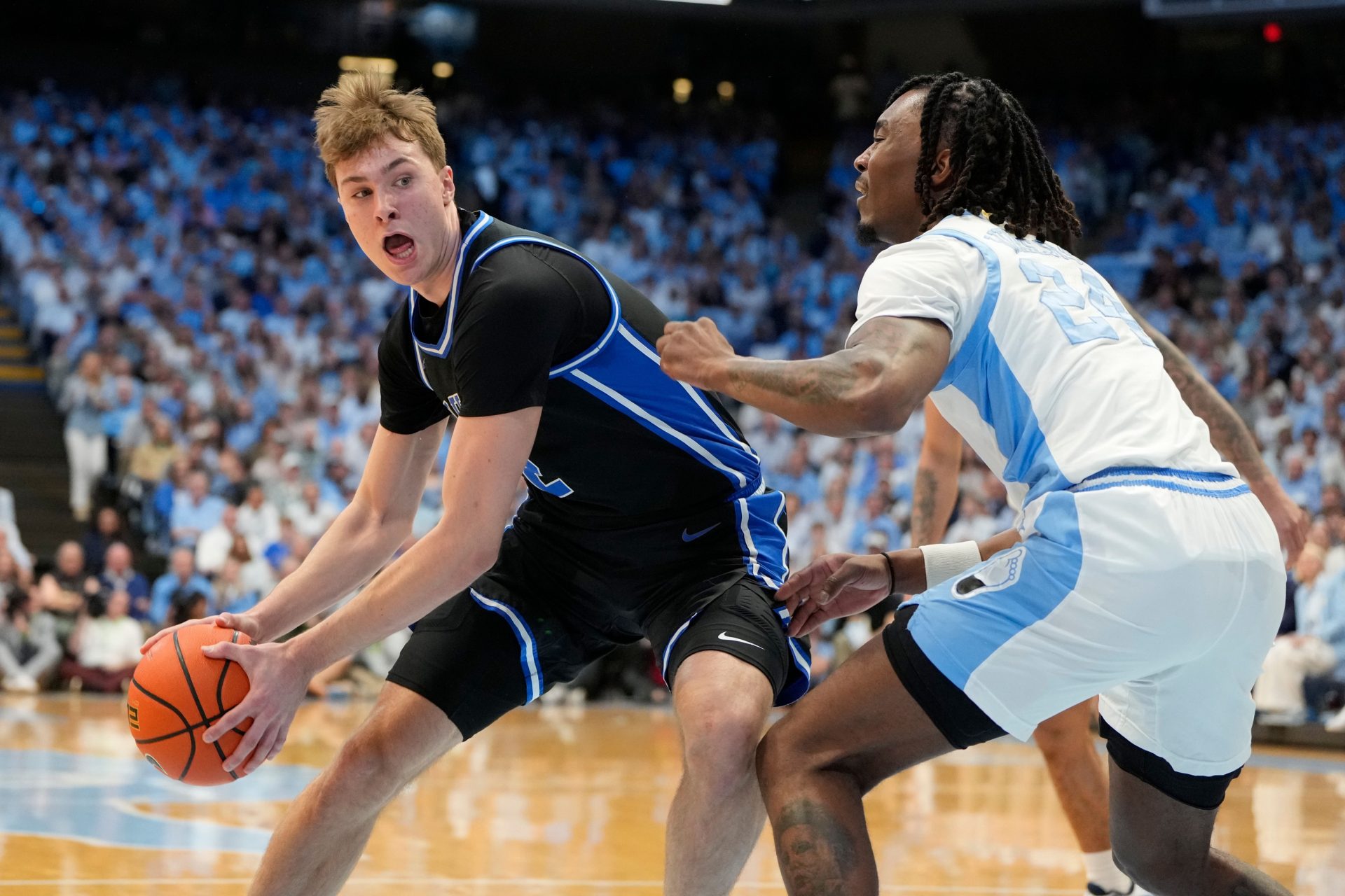 Duke Blue Devils forward Cooper Flagg (2) with the ball as North Carolina Tar Heels forward Jae'Lyn Withers (24) defend in the first half at Dean E. Smith Center.