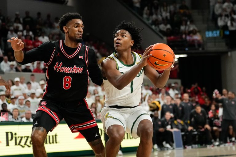 Baylor Bears guard Robert Wright III (1) looks to shoots as Houston Cougars guard Mylik Wilson (8) defends during the second half at Paul and Alejandra Foster Pavilion.