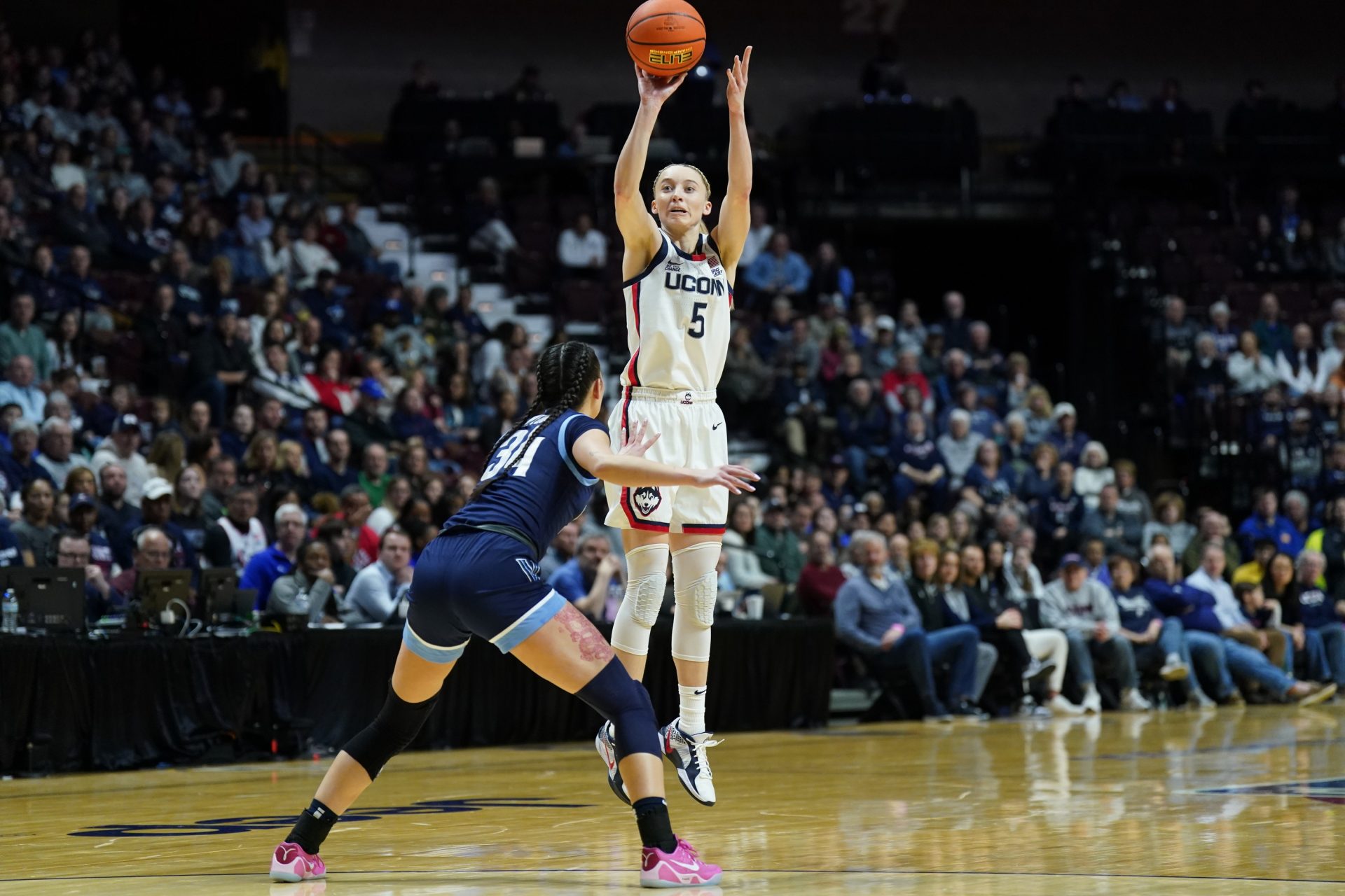 UConn Huskies guard Paige Bueckers (5) shoots against Villanova Wildcats guard Maddie Webber (34) in the first half at Mohegan Sun Arena.