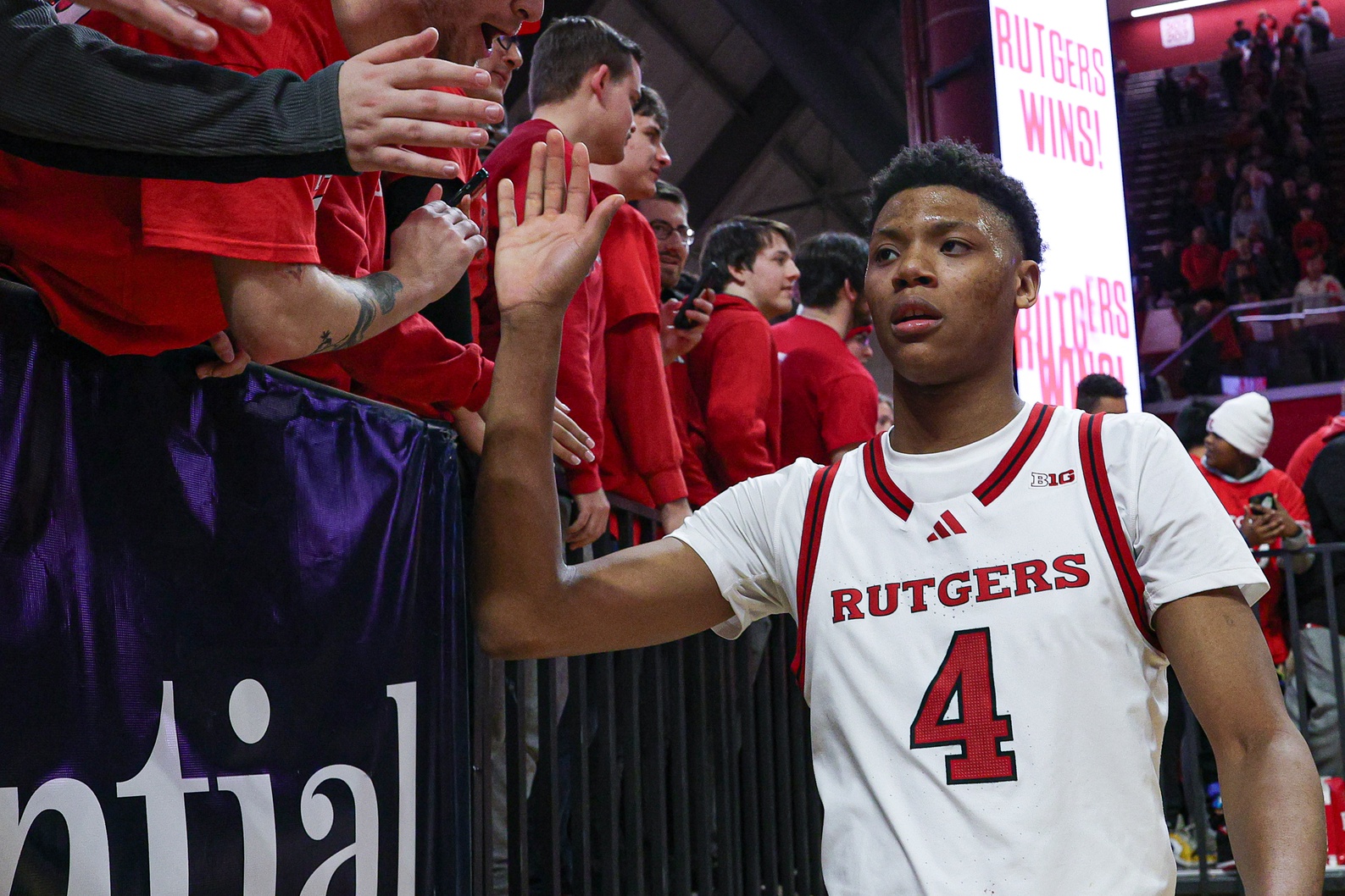 Rutgers Scarlet Knights guard Ace Bailey (4) slap hands with fans after the game against the Minnesota Golden Gophers at Jersey Mike's Arena.