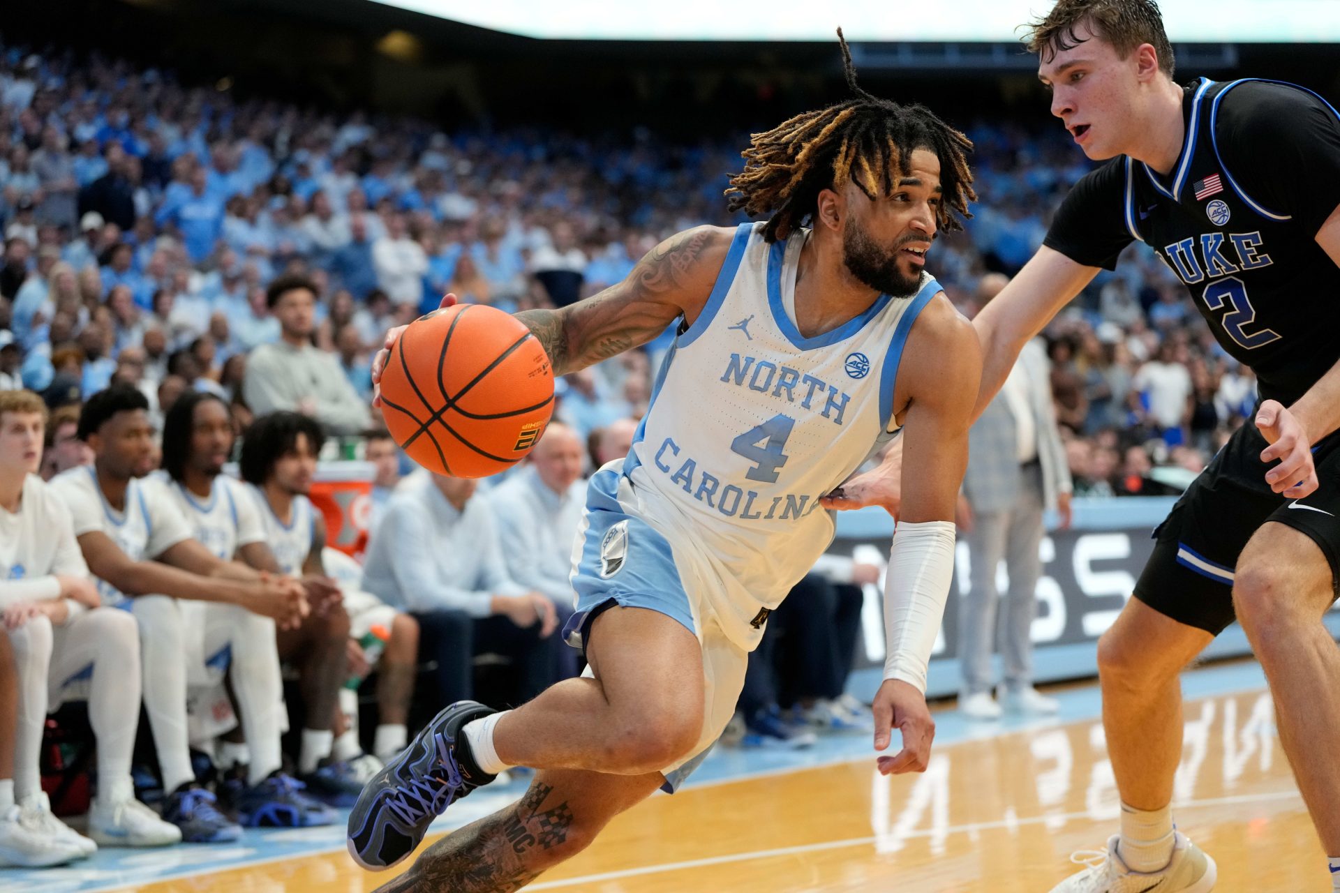 North Carolina Tar Heels guard RJ Davis (4) with the ball as Duke Blue Devils forward Cooper Flagg (2) defends in the second half at Dean E. Smith Center.