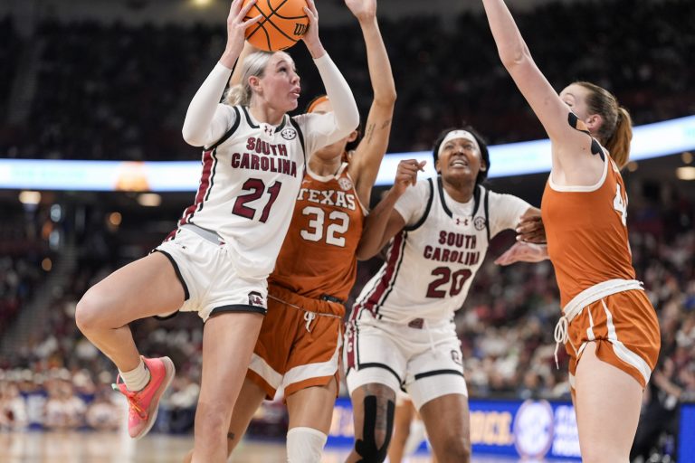 South Carolina Gamecocks forward Chloe Kitts (21) drives to the basket against Texas Longhorns guard Ndjakalenga Mwenentanda (32) and forward Taylor Jones (44) during the second half at Bon Secours Wellness Arena.