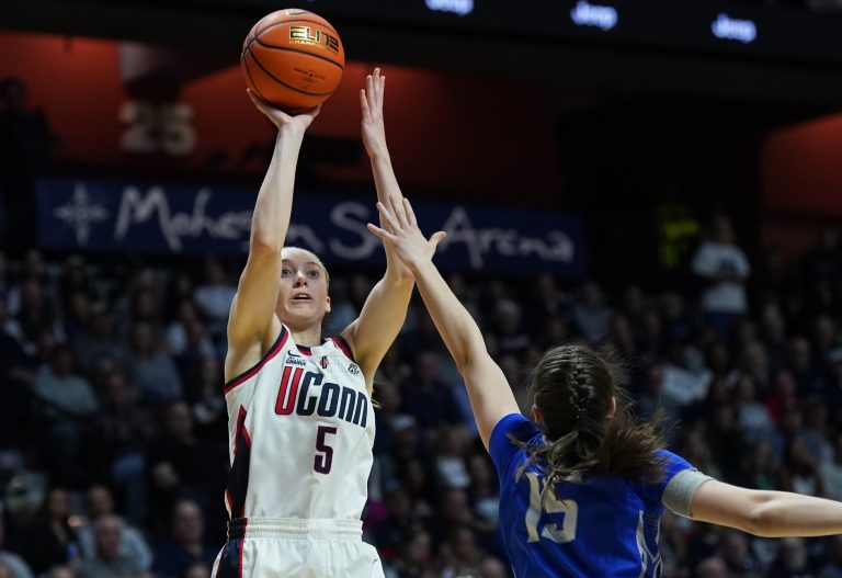 UConn Huskies guard Paige Bueckers (5) shoots the ball against Creighton Bluejays guard Lauren Jensen (15) in the first half at Mohegan Sun Arena.