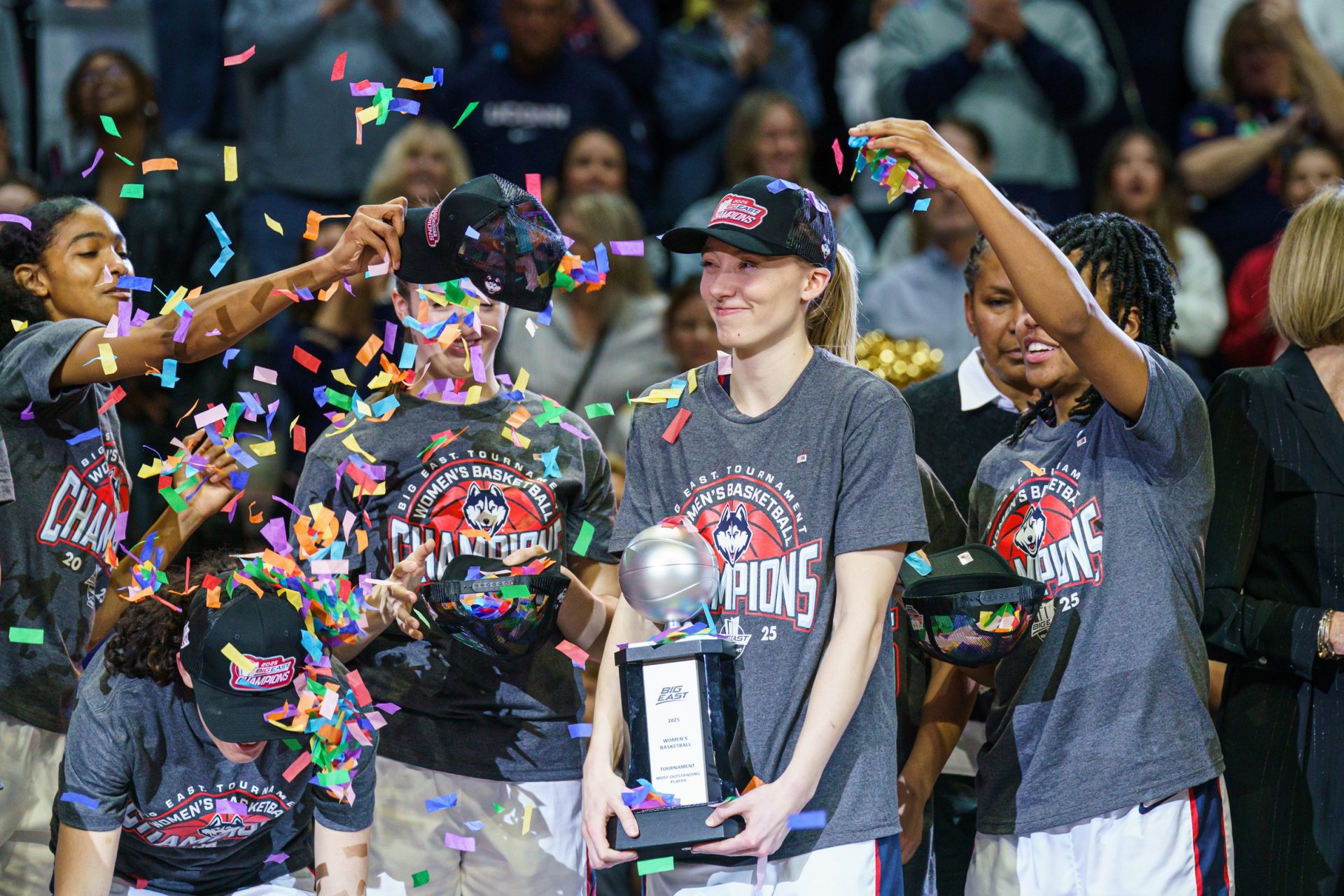 UConn Huskies guard Paige Bueckers (5) holds her “Most Outstanding Player” trophy as the team celebrates their Big East Championship win over the Creighton Bluejays at Mohegan Sun Arena.