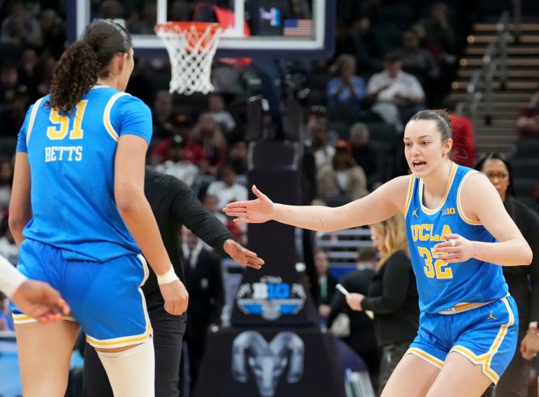 UCLA Bruins forward Angela Dugalić (32) high fives center Lauren Betts (51) as she comes off the court during the second half of the 2025 TIAA Big Ten Women's Basketball Tournament final game against the USC Trojans on Sunday, March 9, 2025, at Gainbridge Fieldhouse in Indianapolis. UCLA defeated USC 72-67.