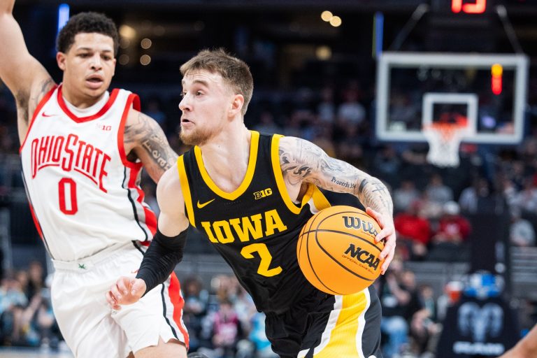 Iowa Hawkeyes guard Brock Harding (2) dribbles the ball while Ohio State Buckeyes guard John Mobley Jr. (0) defends in the first half at Gainbridge Fieldhouse.