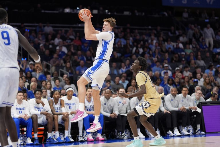 Duke Blue Devils forward Cooper Flagg (2) leaps for a rebound defended by Georgia Tech Yellow Jackets forward Baye Ndongo (11) during the first half at Spectrum Center.