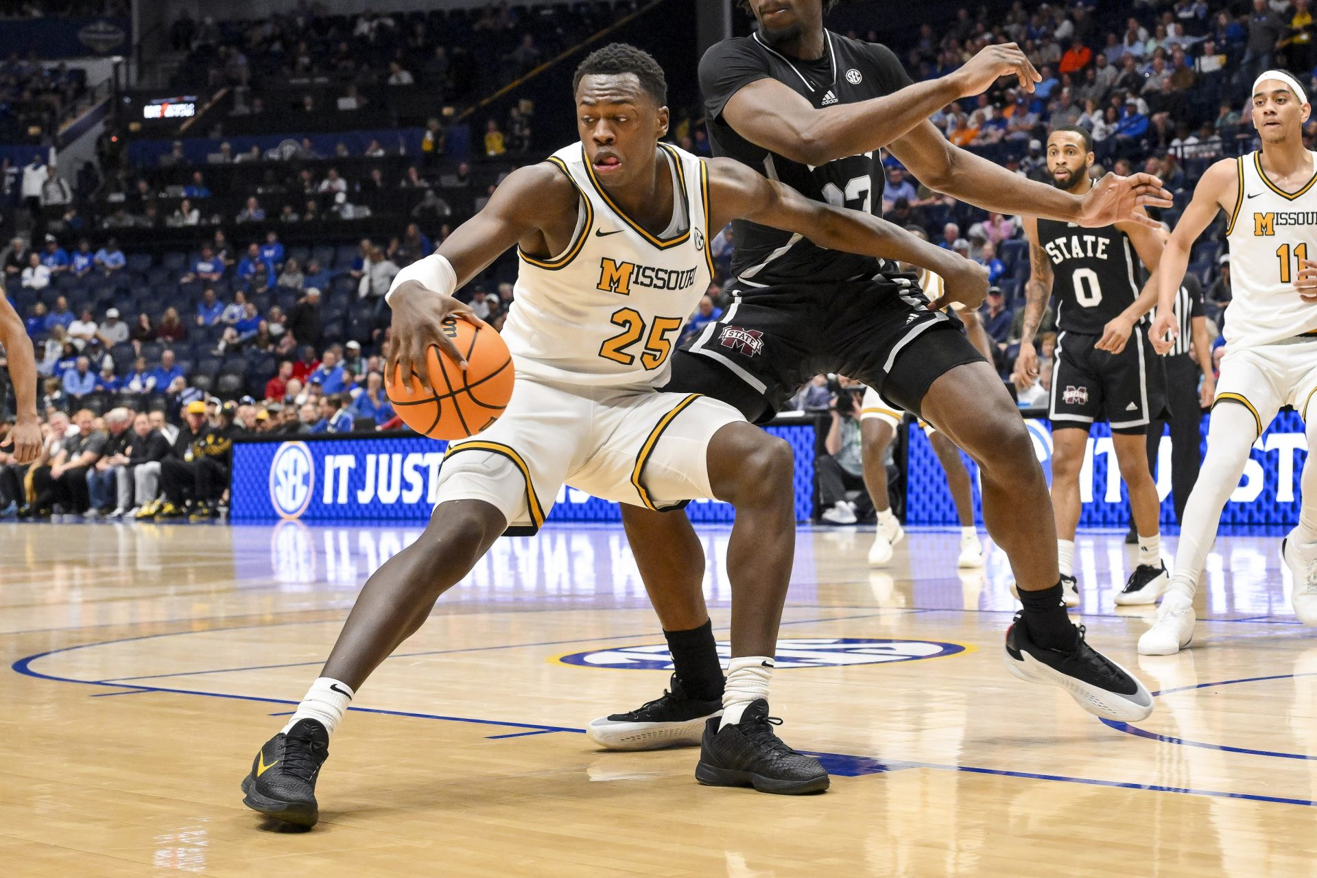 Missouri Tigers guard Mark Mitchell (25) dribbles the ball against the Mississippi State Bulldogs during the first half at Bridgestone Arena.