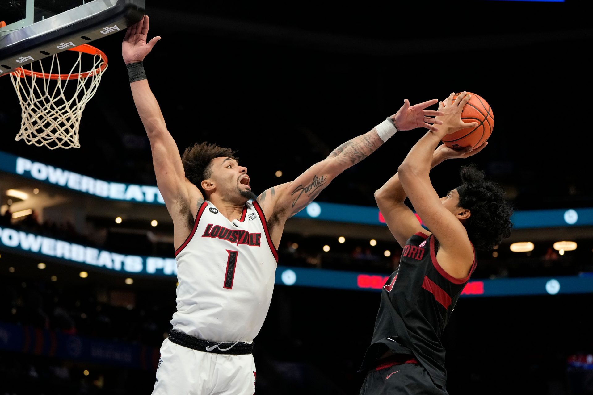 Stanford Cardinal guard Ryan Agarwal (11) shoots as Louisville Cardinals guard J'Vonne Hadley (1) defends in the second half at Spectrum Center.