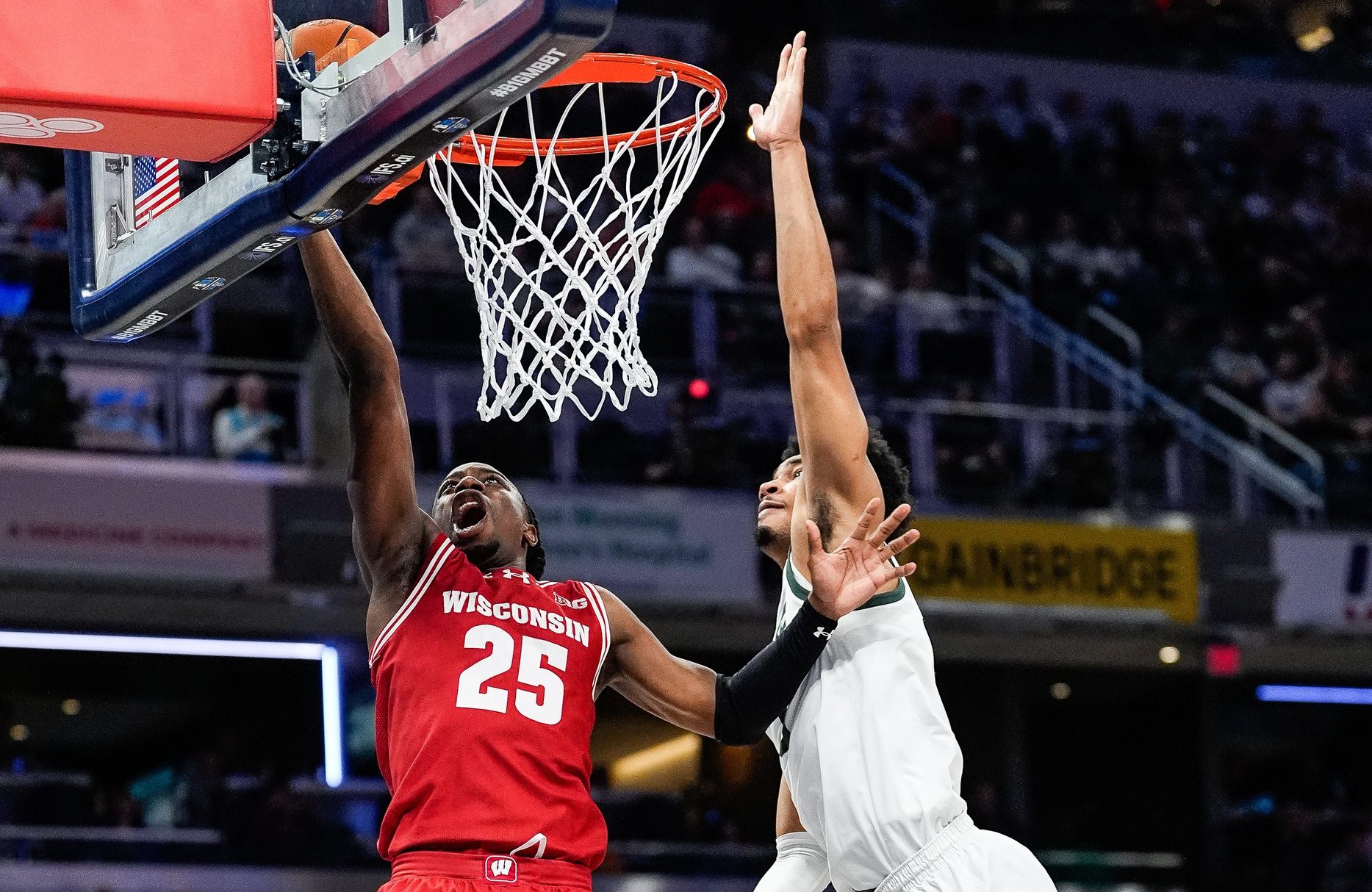 Michigan State guard Jaden Akins (3) tries to block a layup from Wisconsin guard John Blackwell (25) during the first half of Big Ten Tournament semifinal at Gainbridge Fieldhouse in Indianapolis, Ind. on Saturday, March 15, 2025.