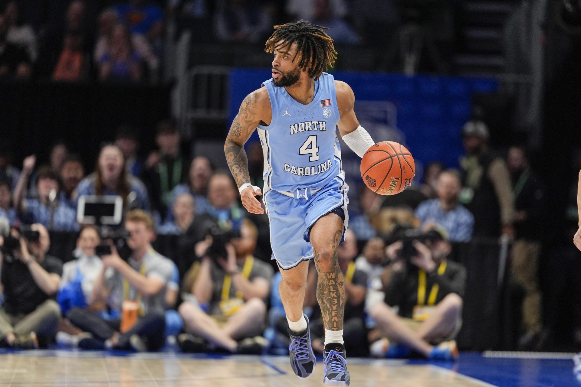 North Carolina Tar Heels guard RJ Davis (4) brings the ball up court against the Duke Blue Devils during the first half at Spectrum Center.