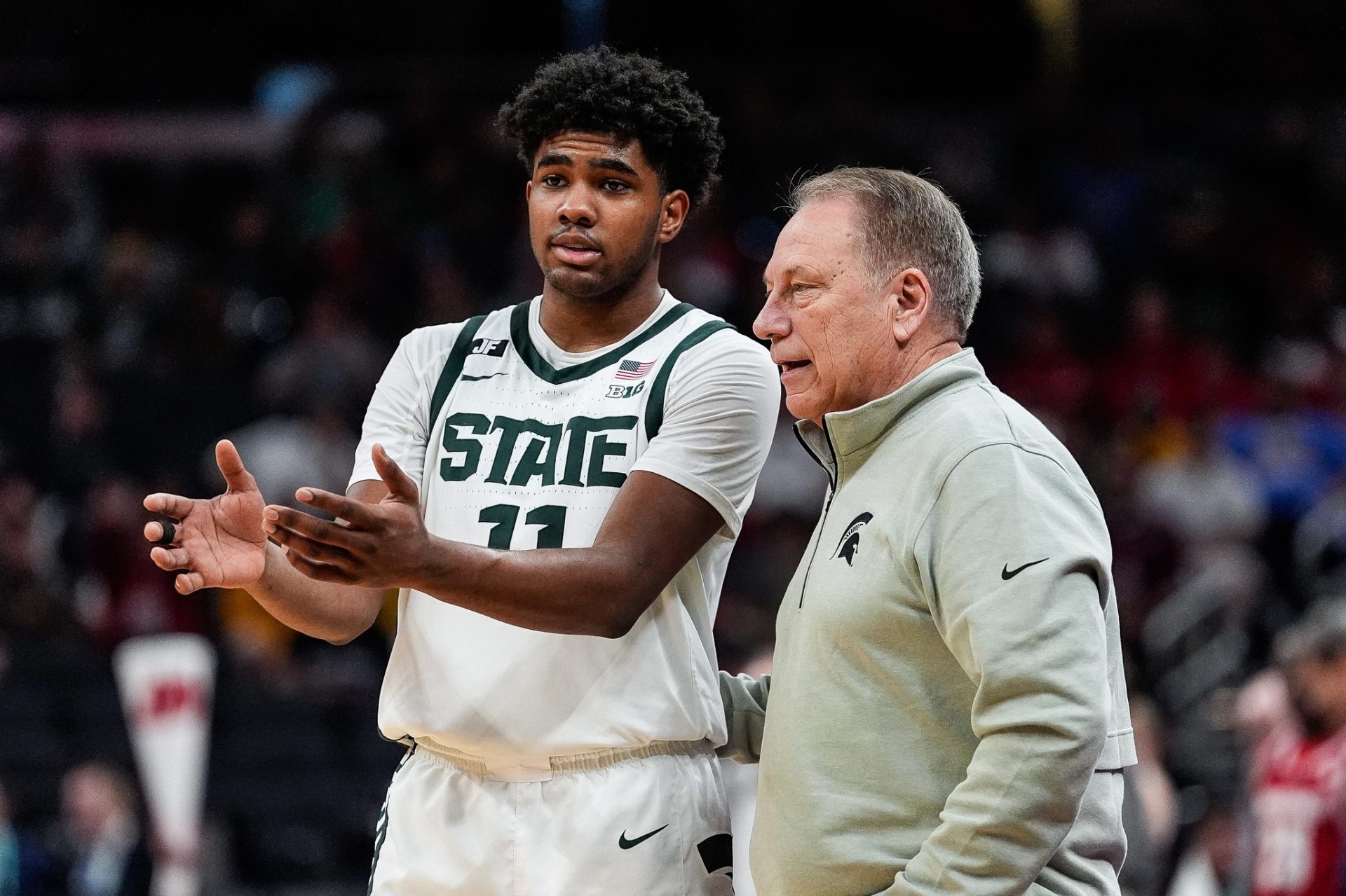 Michigan State guard Jase Richardson (11) talks to head coach Tom Izzo before a play against Wisconsin during the first half of Big Ten Tournament semifinal at Gainbridge Fieldhouse in Indianapolis, Ind. on Saturday, March 15, 2025.