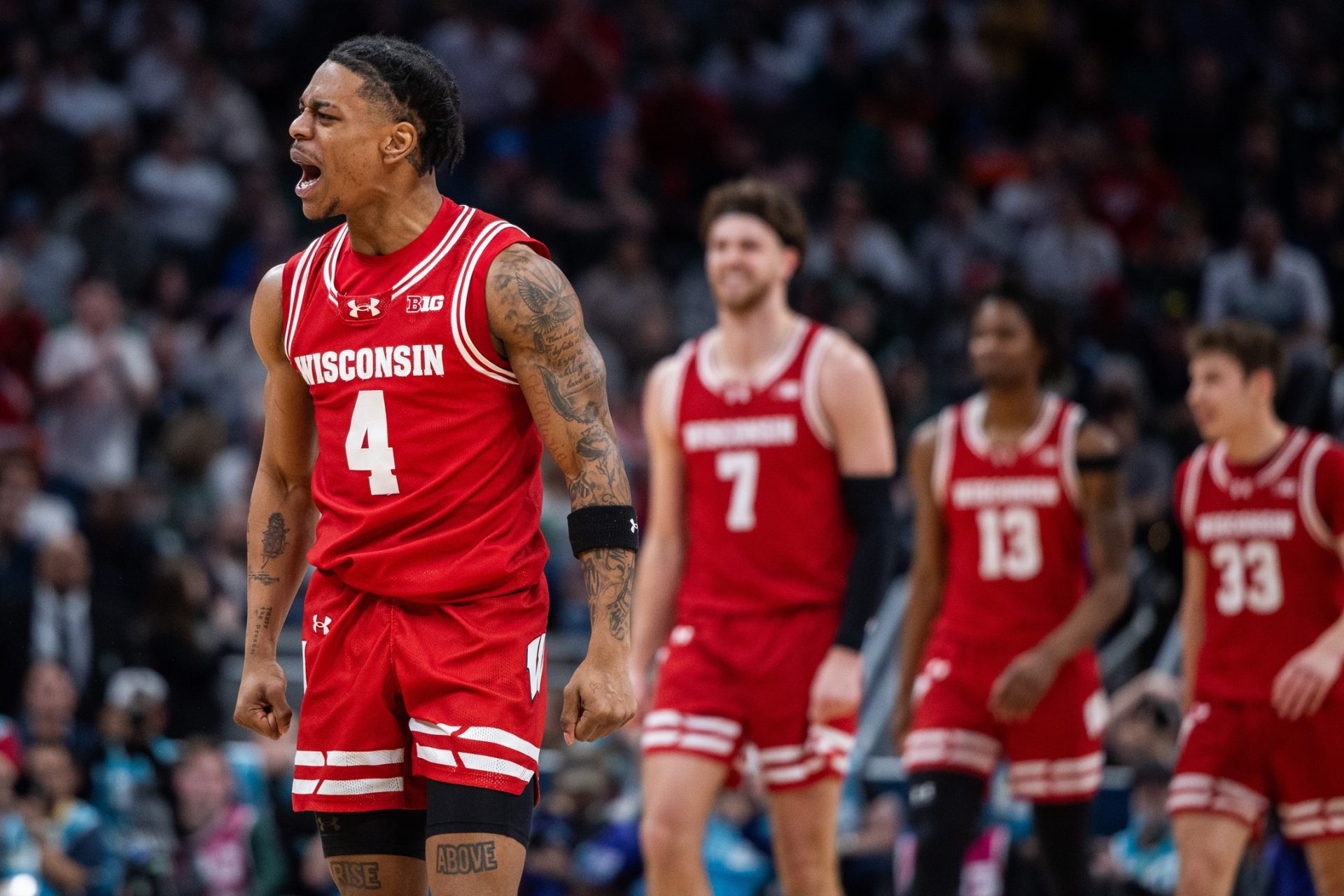 Wisconsin Badgers guard Kamari McGee (4) celebrates a made basket in the second half against the Wisconsin Badgers at Gainbridge Fieldhouse.