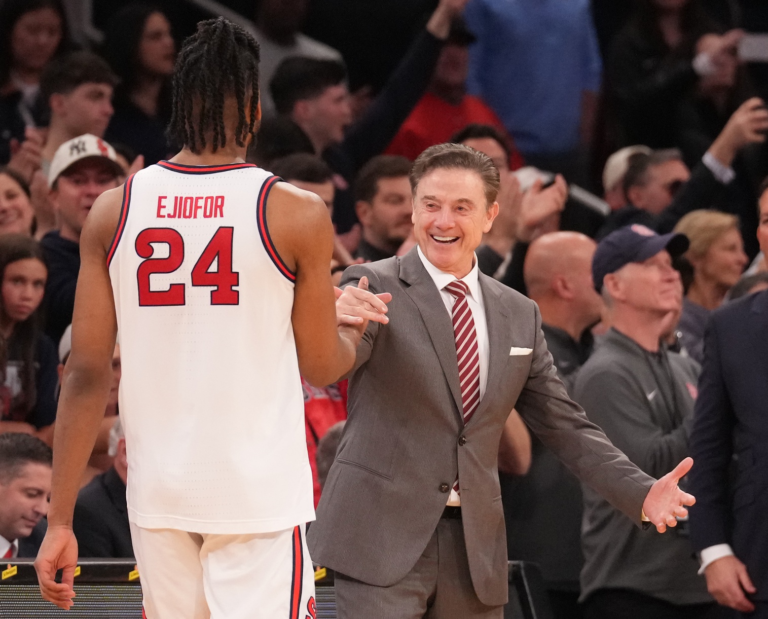 St. John's Red Storm forward Zuby Ejiofor (24) is greeted by St. John's Red Storm head coach Rick Pitino as the game ends against the Creighton Bluejays at Madison Square Garden.